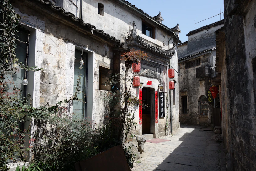 A narrow alleyway leads between old stone buildings.