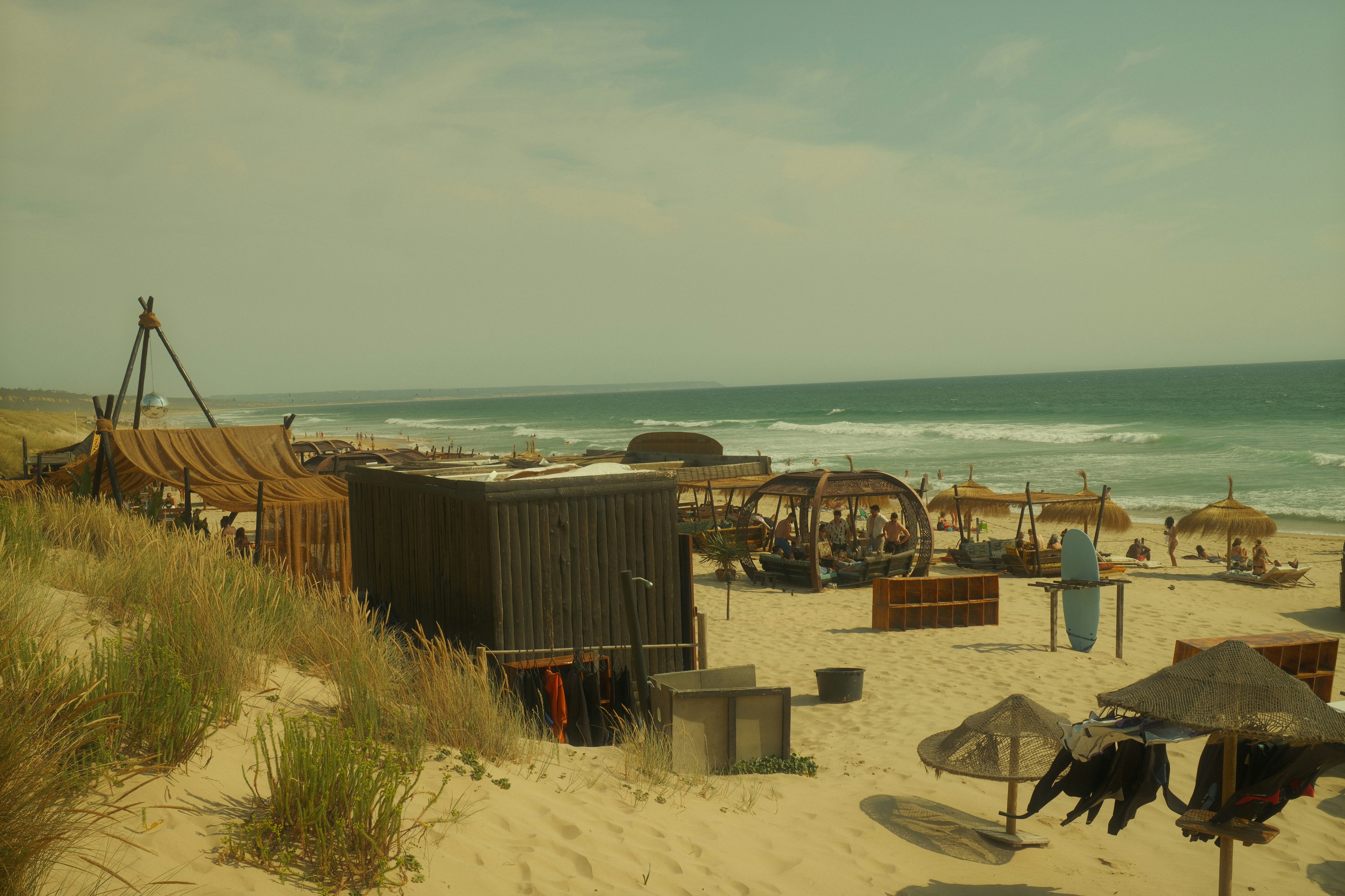 A beach with structures and ocean views.