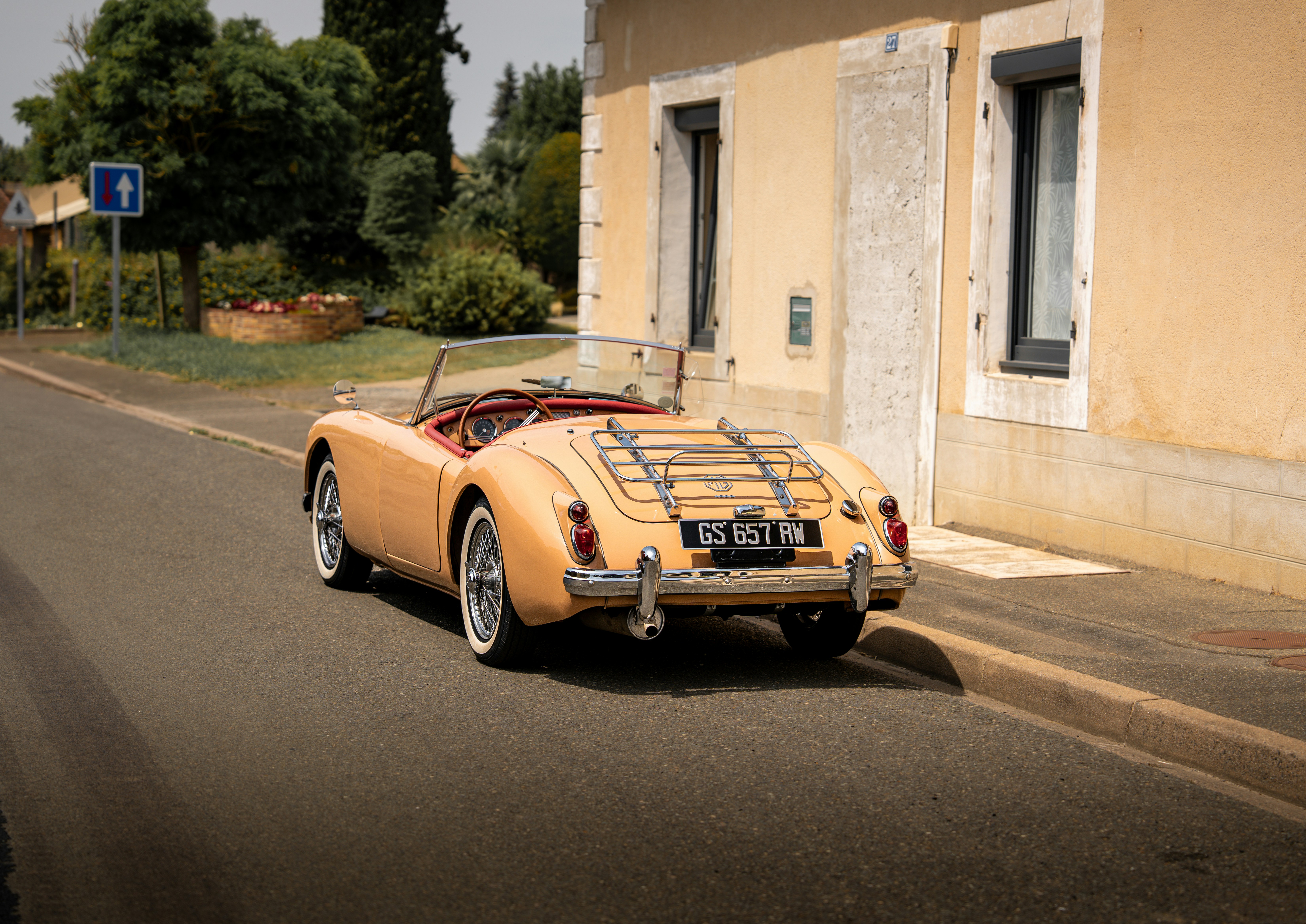 A classic convertible car is parked on the road.