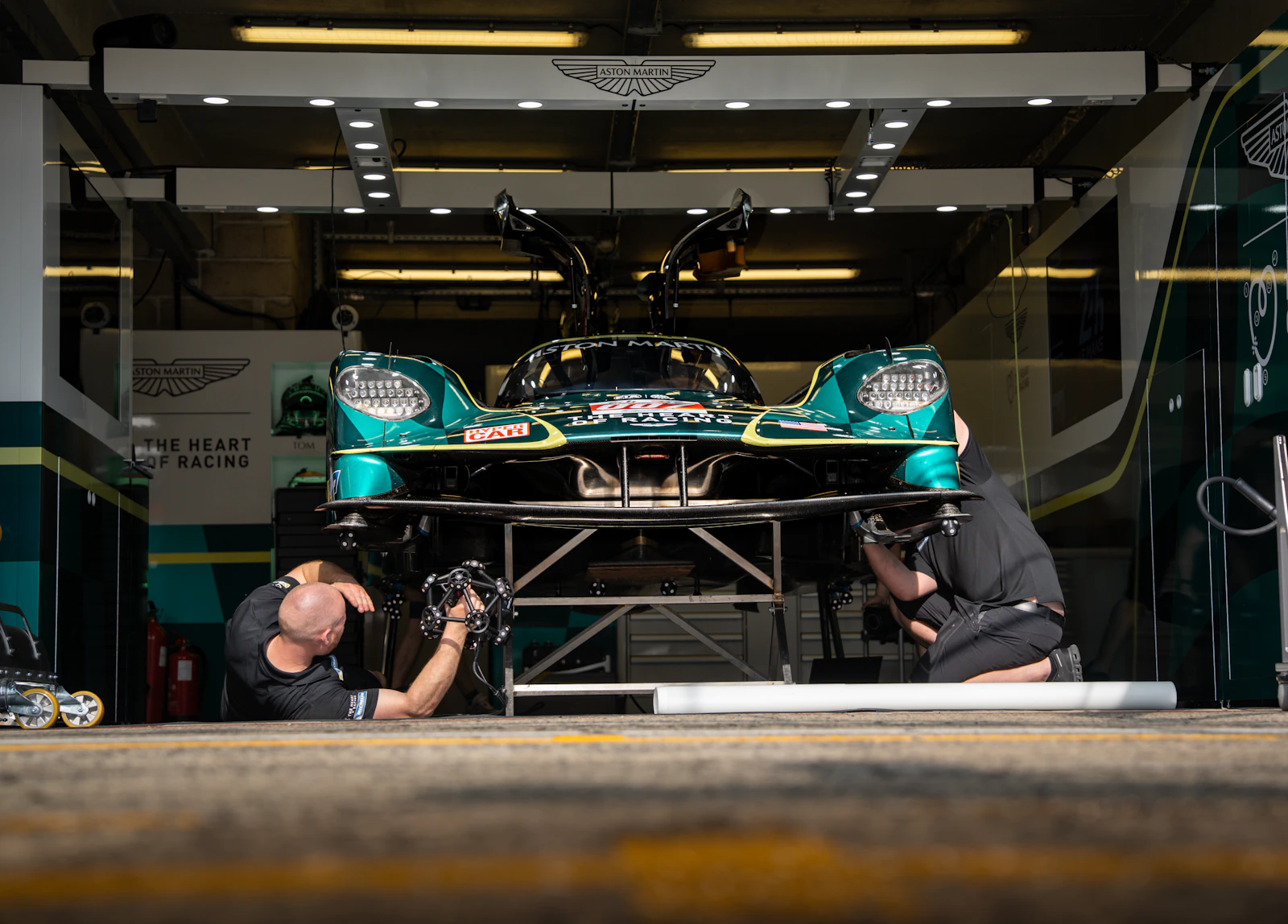 Technicians working on a vehicle in a modern repair shop
