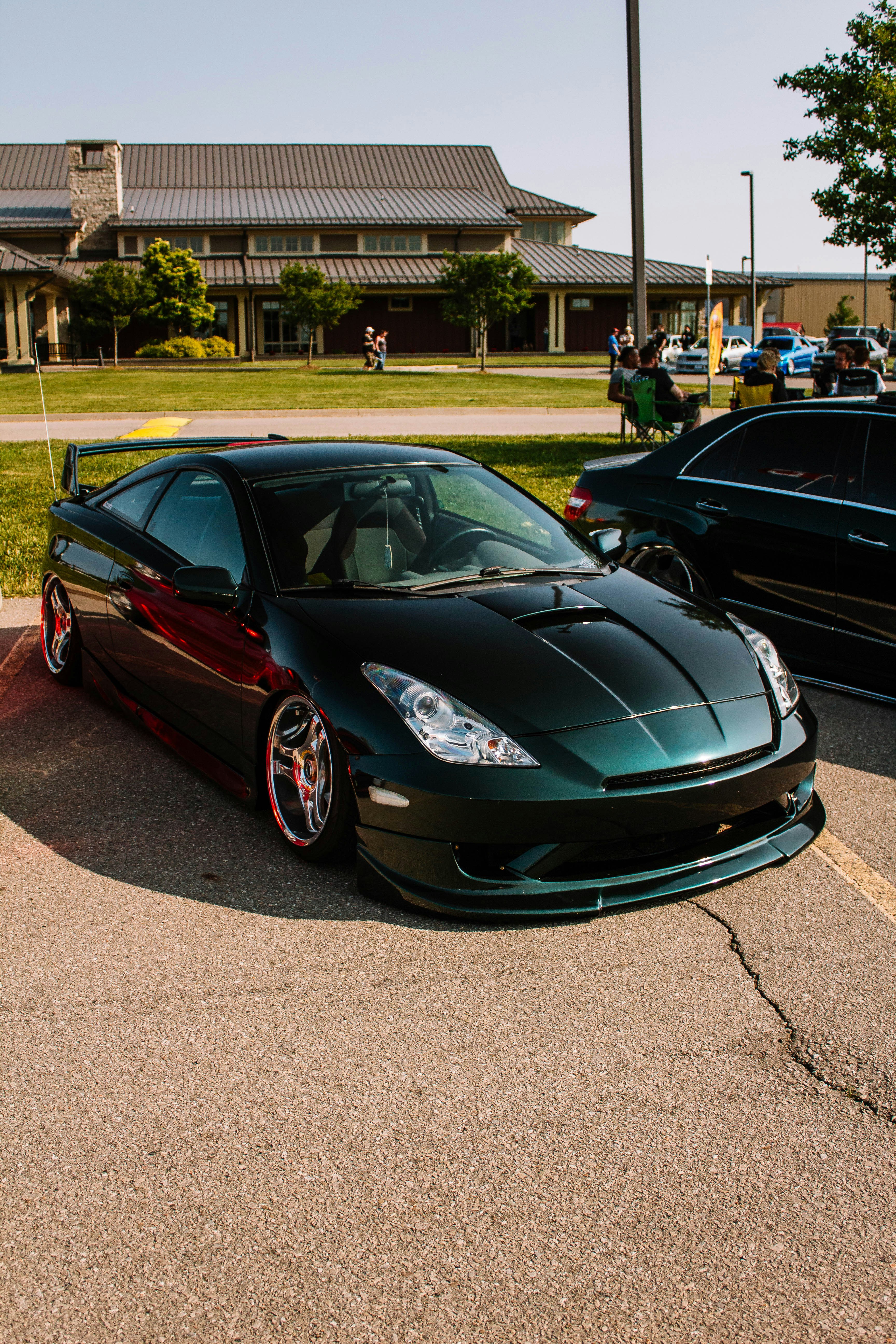 A shiny, dark green toyota celica is displayed