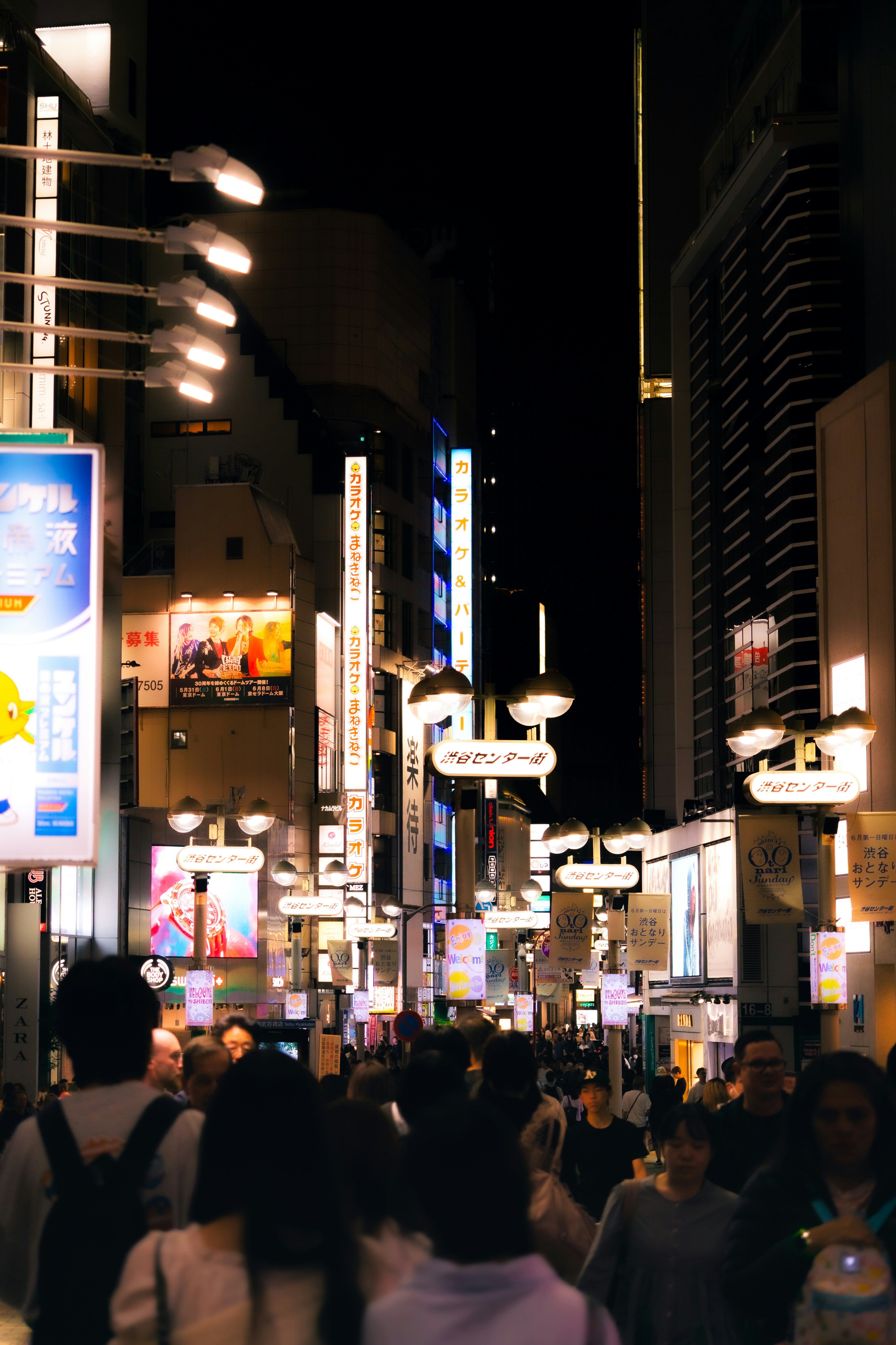 A busy street at night in japan.