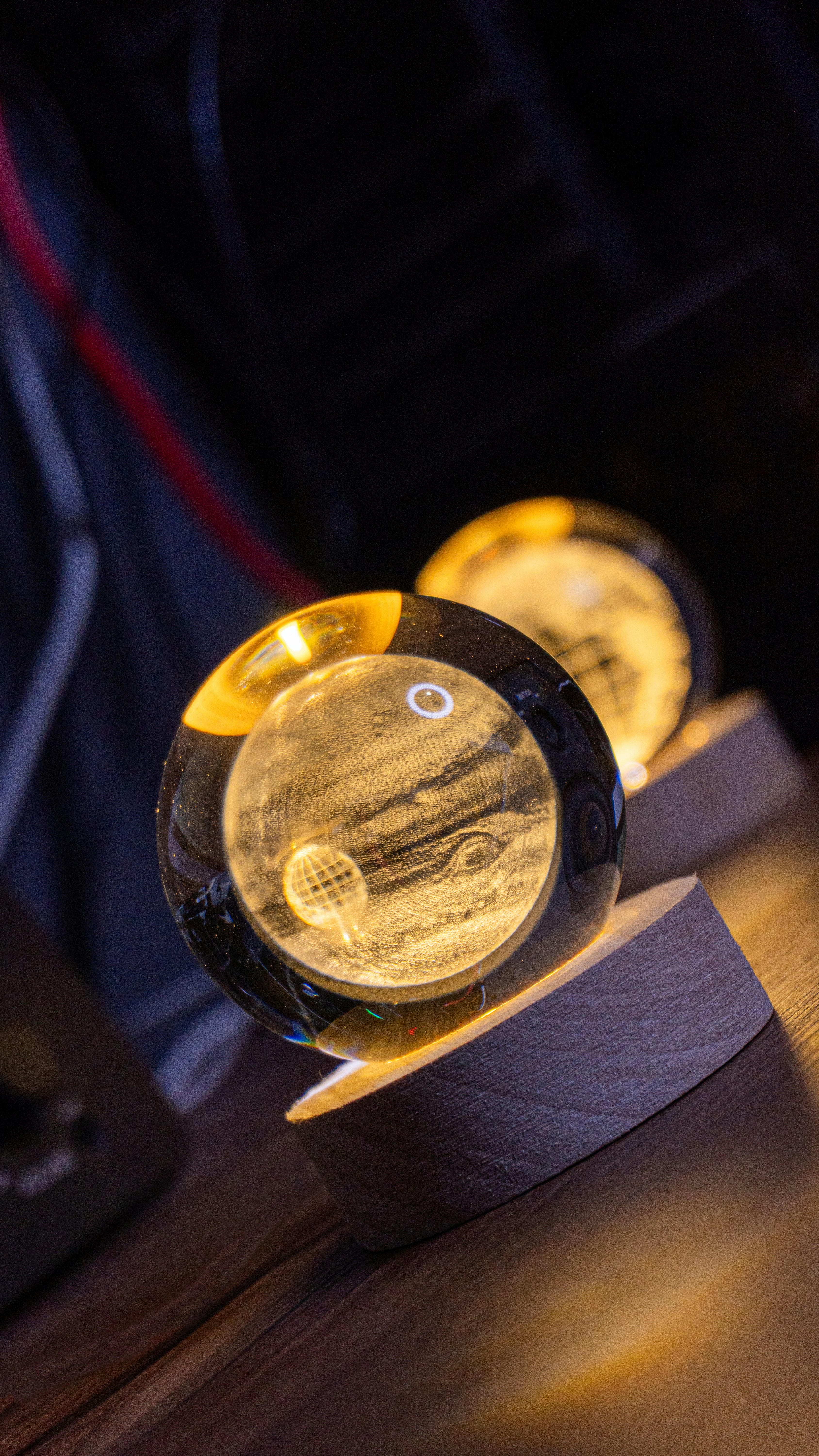 Glowing planet spheres on wooden stands.