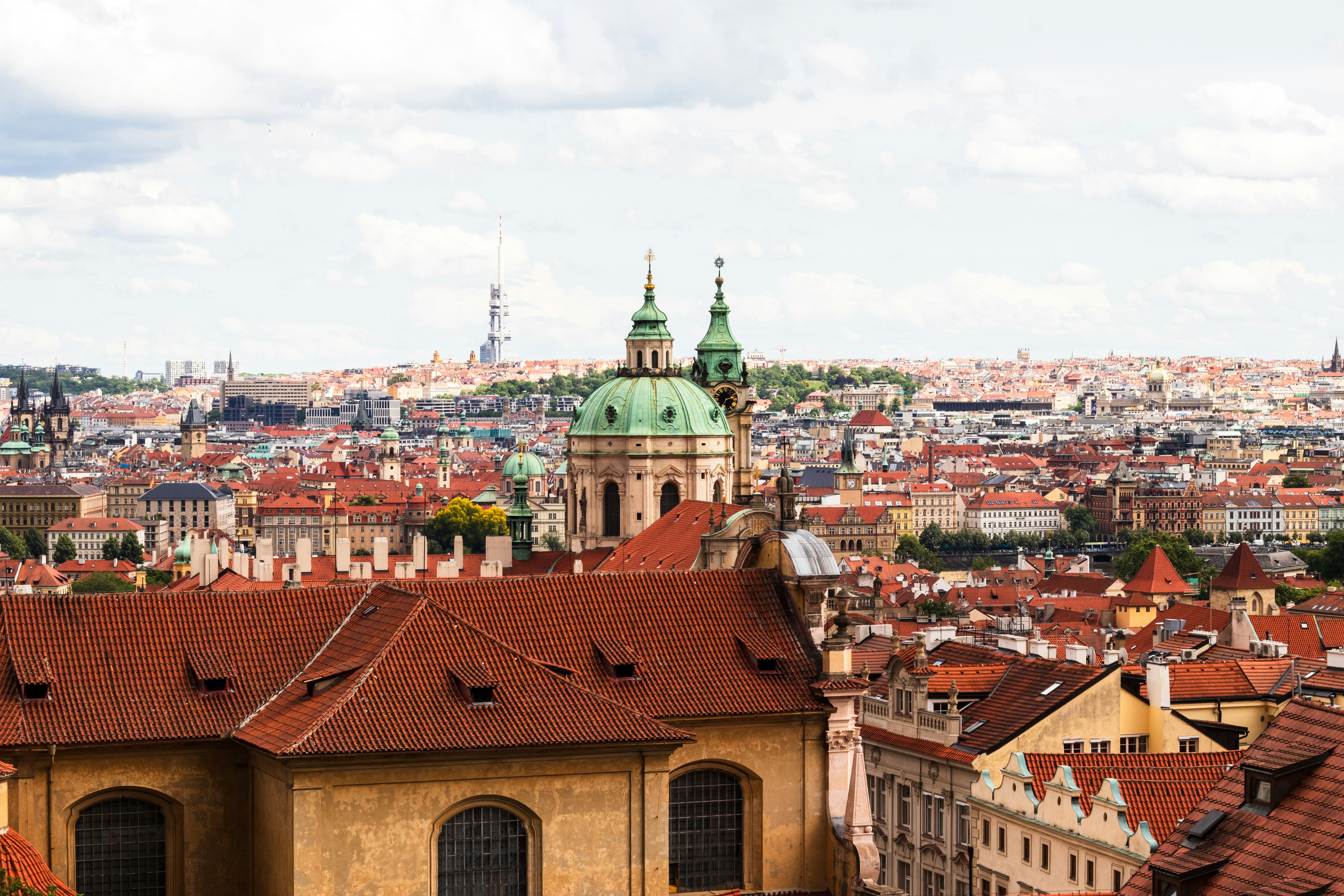 A beautiful cityscape with red roofs and spires.