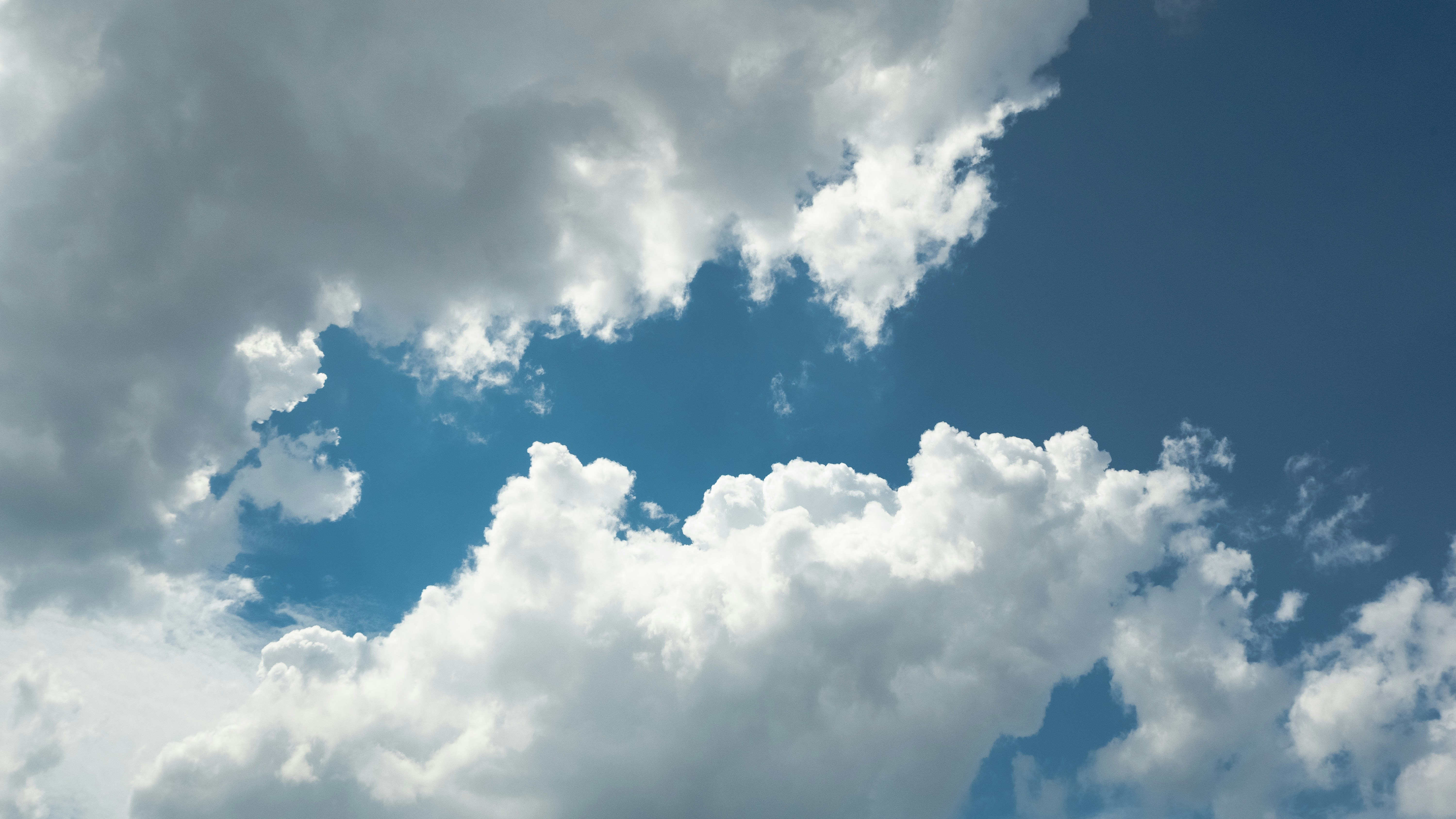 Clouds fill the sky with a bright blue space.