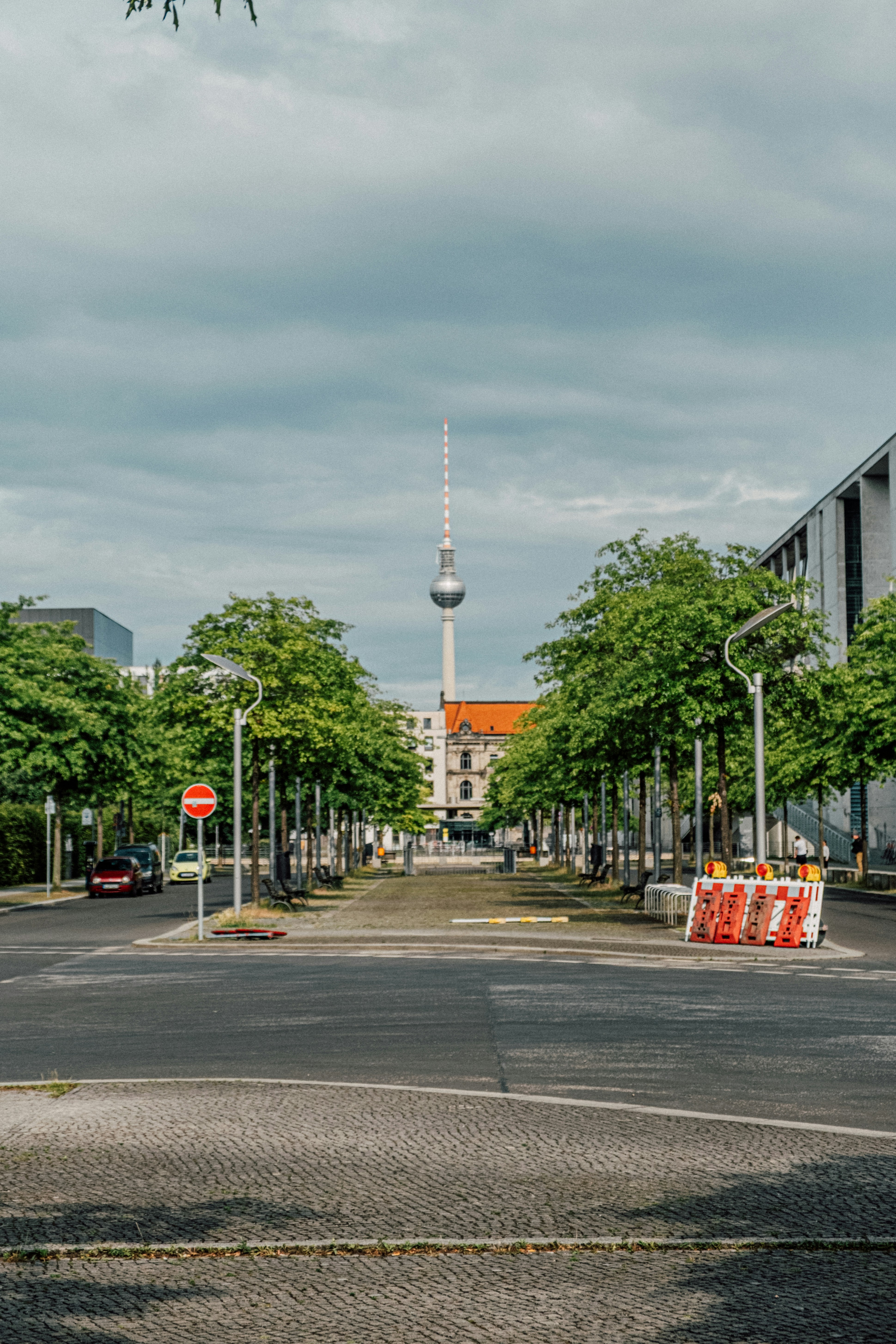 A berlin street with the TV tower in view.