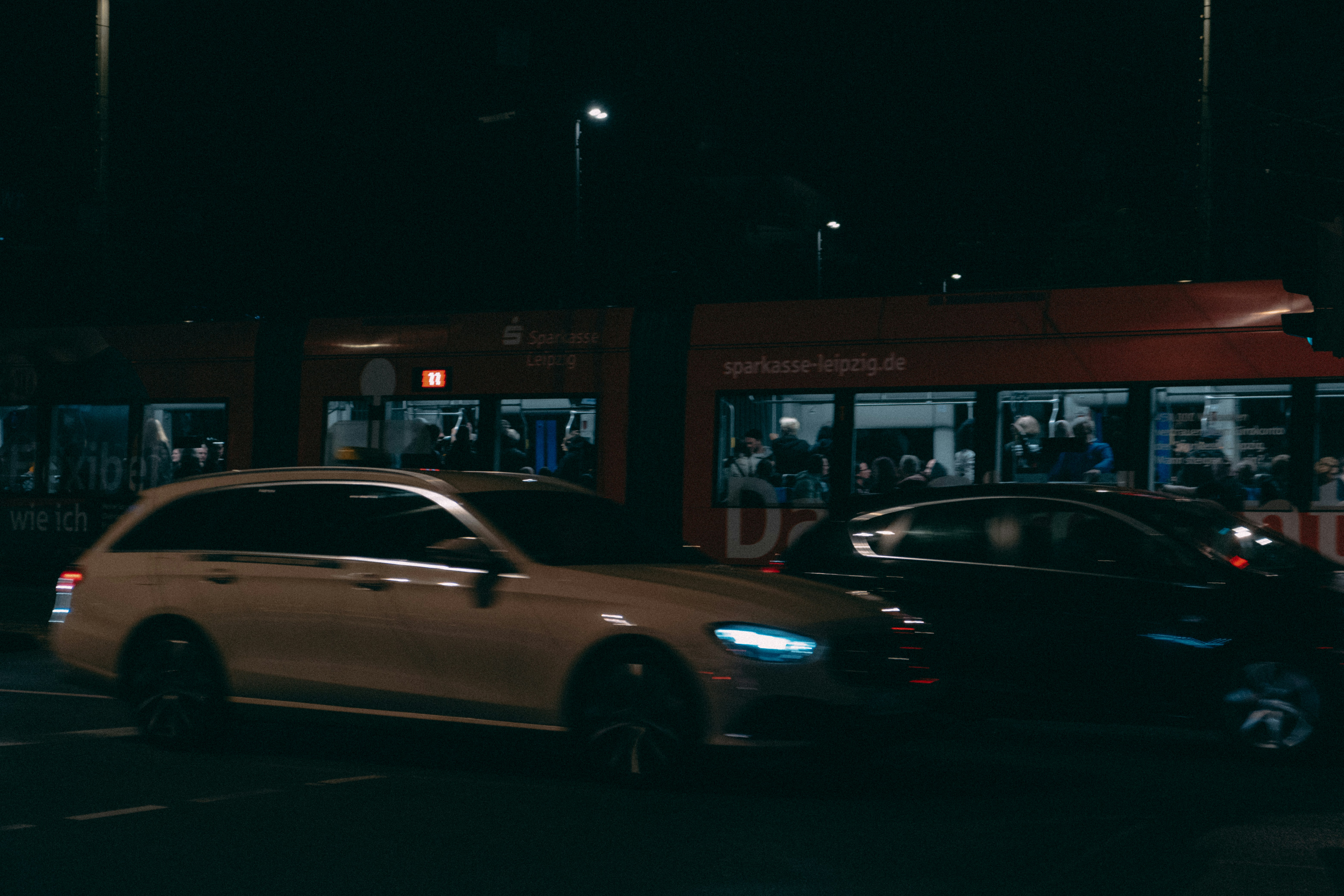 Family looking at an electric car in a dealership, discussing range and charging needs