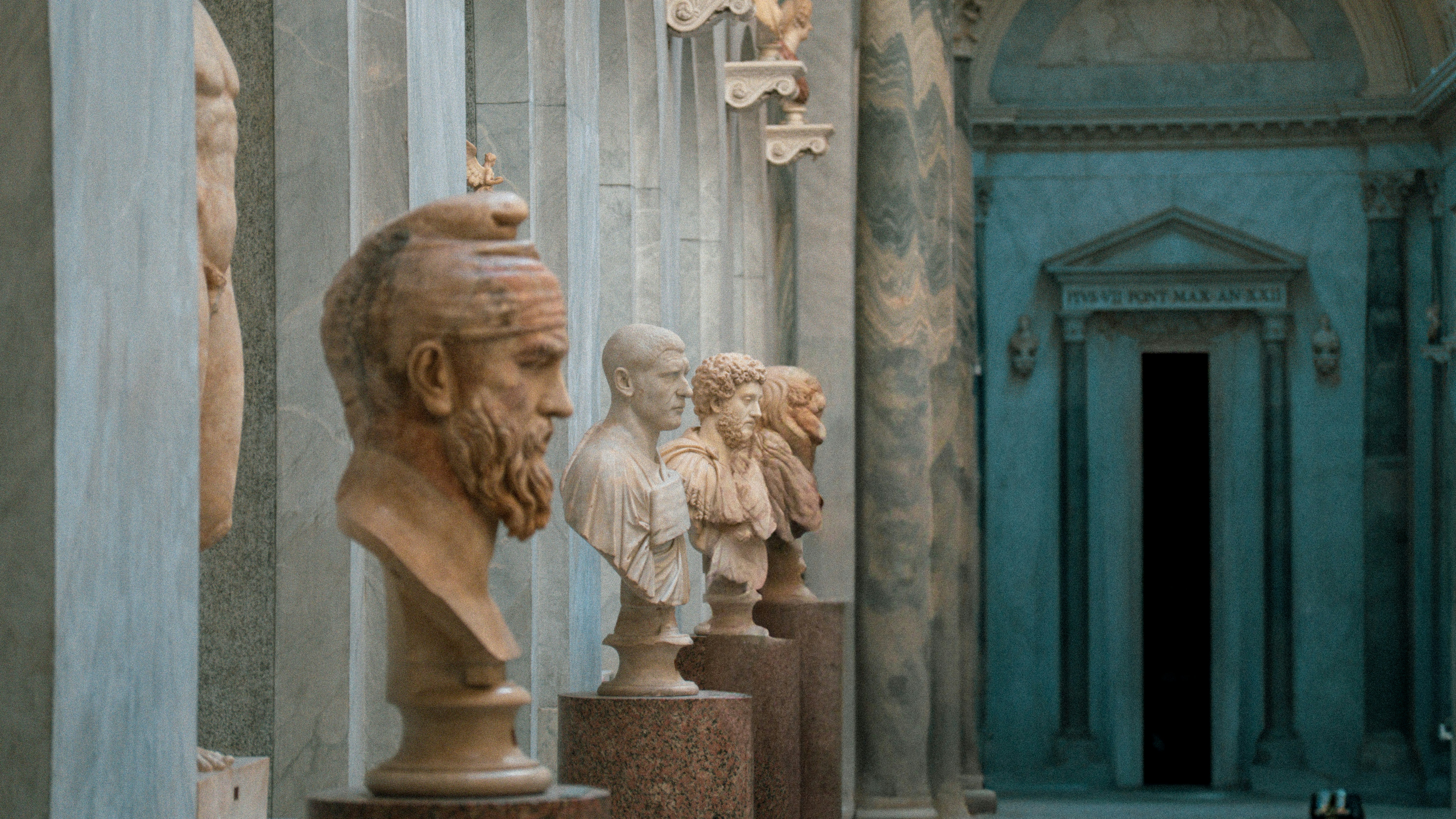 A row of antique busts is on display.