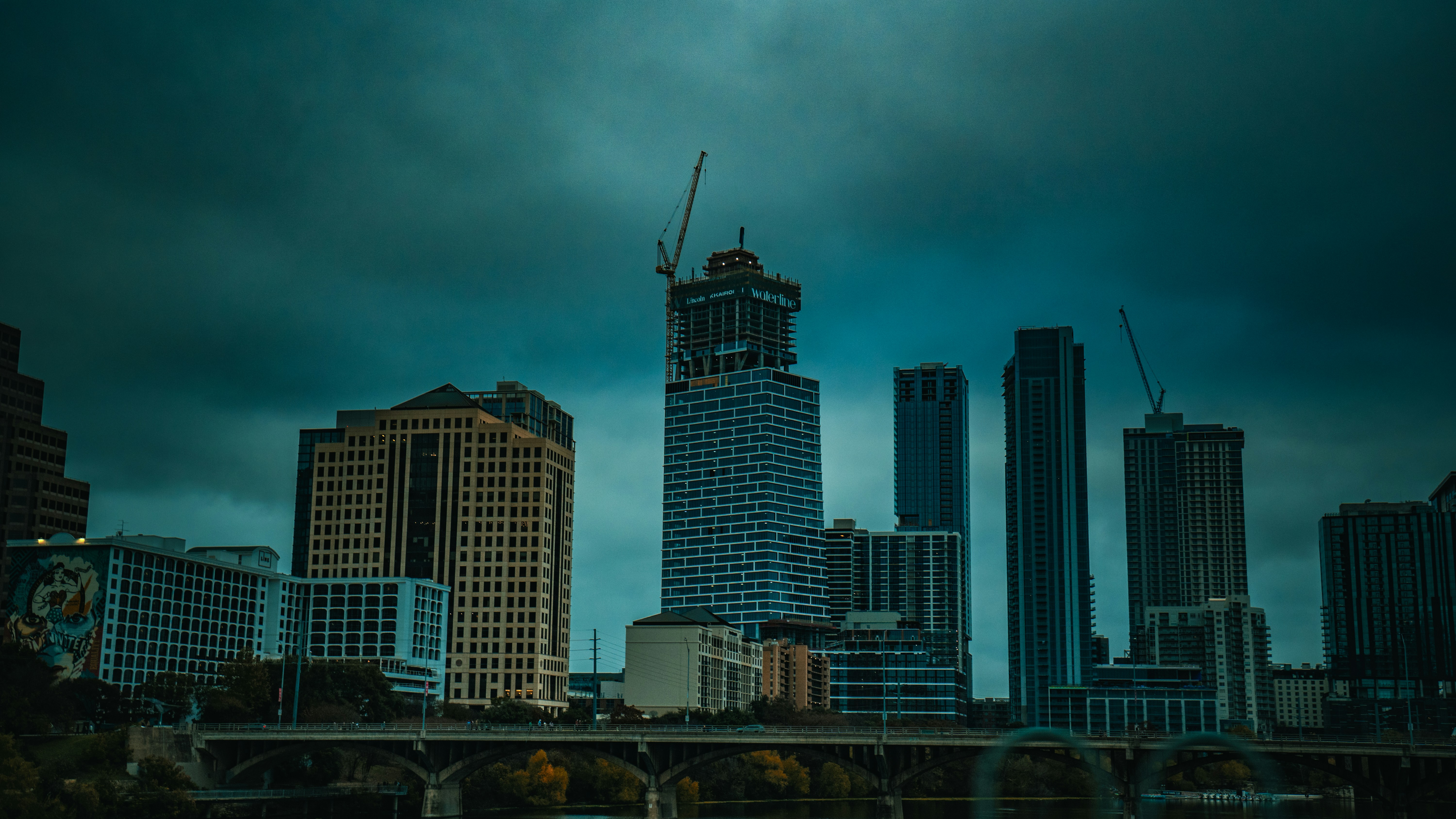 Commercial building skyline in Texas with a storm approaching, symbolizing property damage challenges - what is an inside property claims adjuster