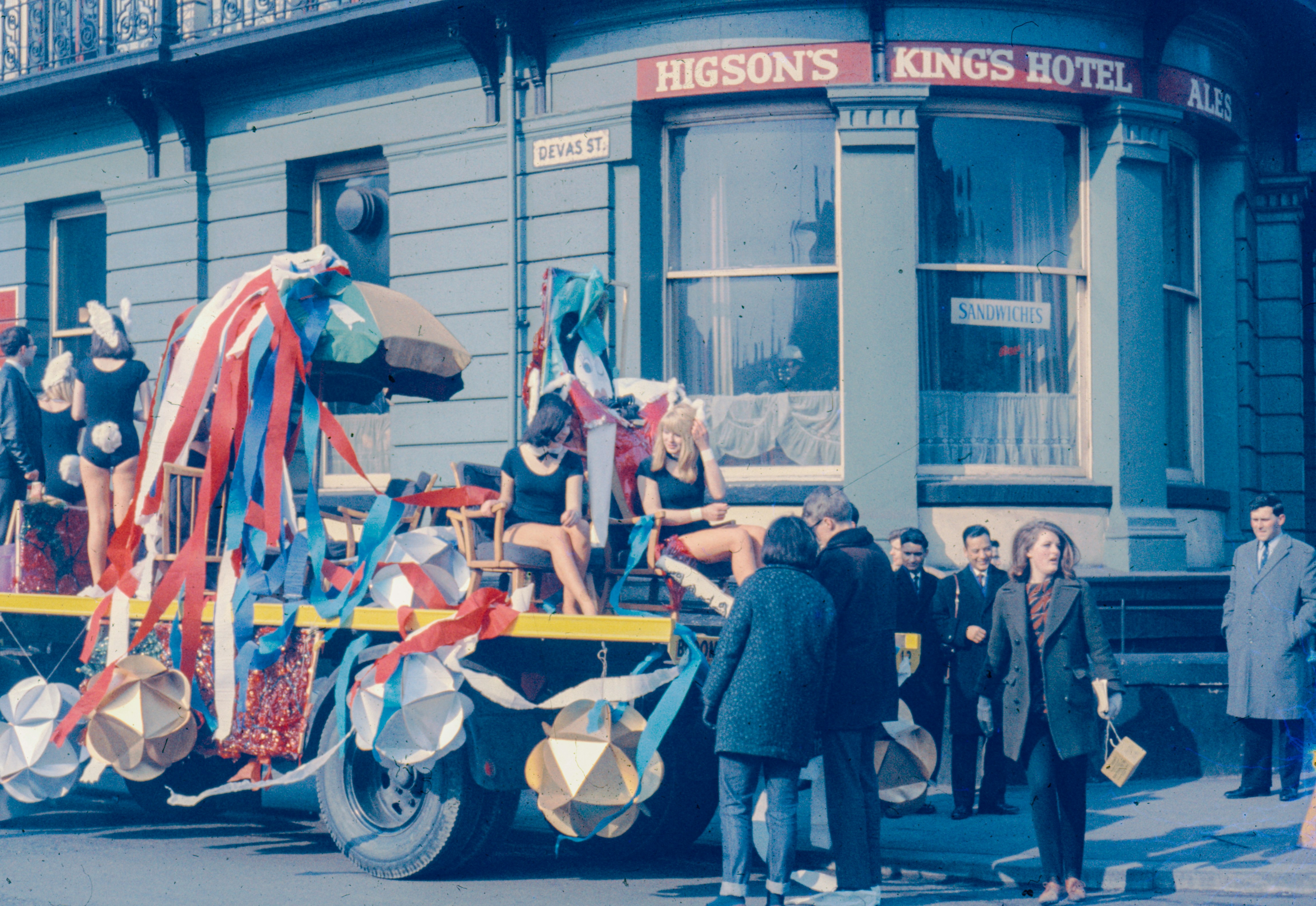 A parade float outside a hotel is shown.