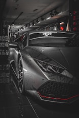 A sleek lamborghini parked in a dimly lit store.
