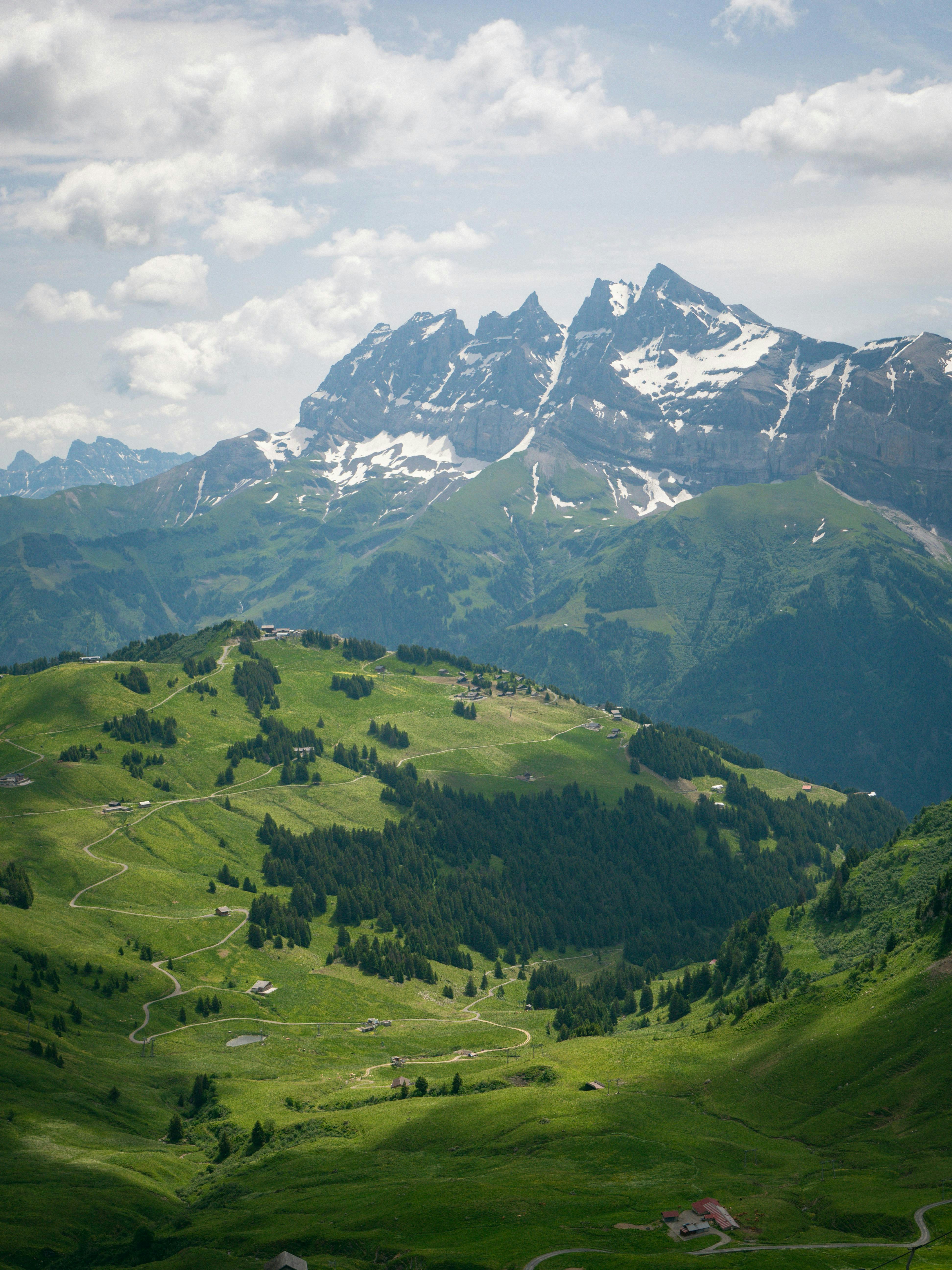 Majestic mountains rise above lush green valleys.