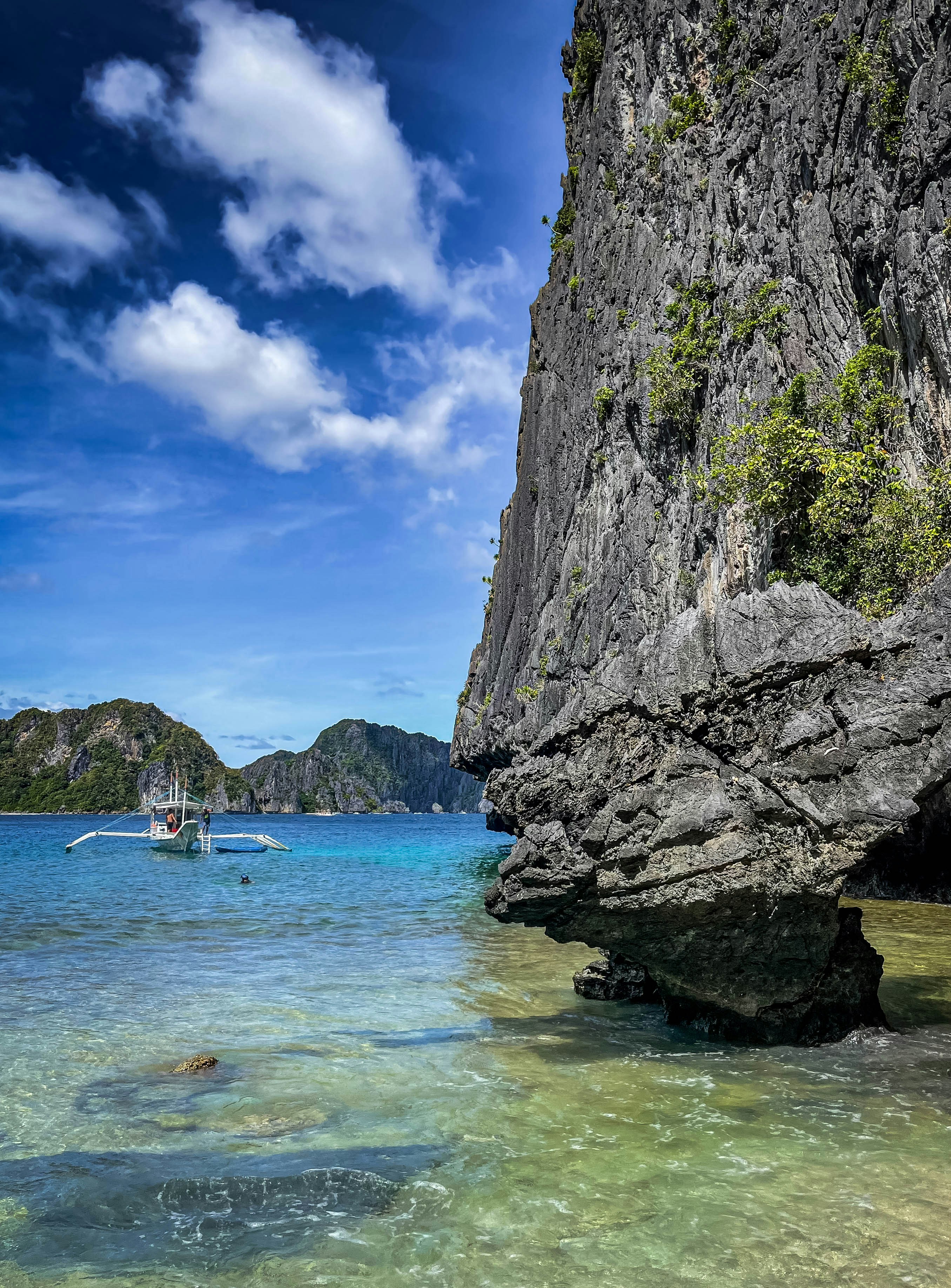 Scenic island coast with clear water and rock formations.