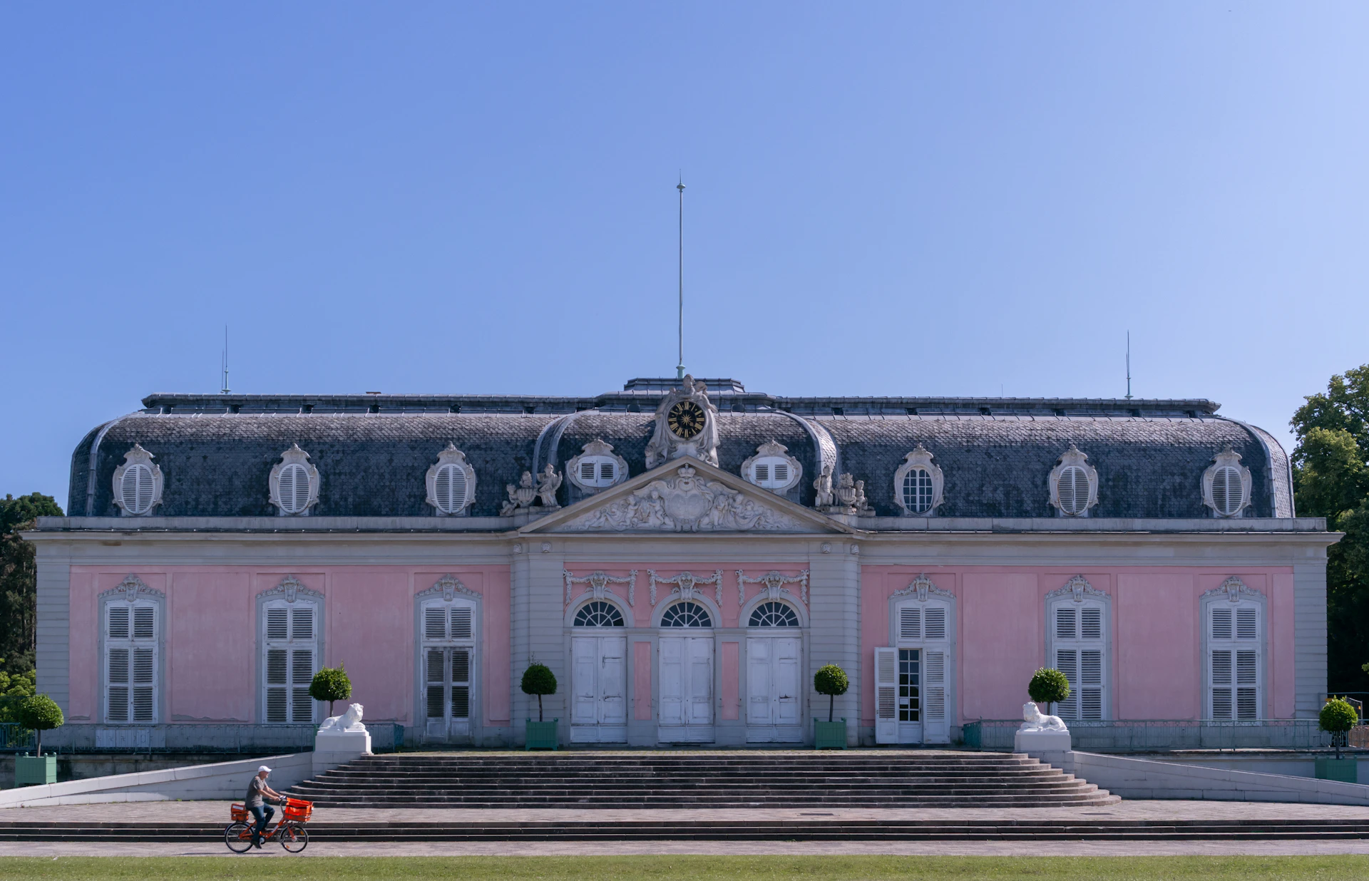 A pink palace stands against a blue sky.