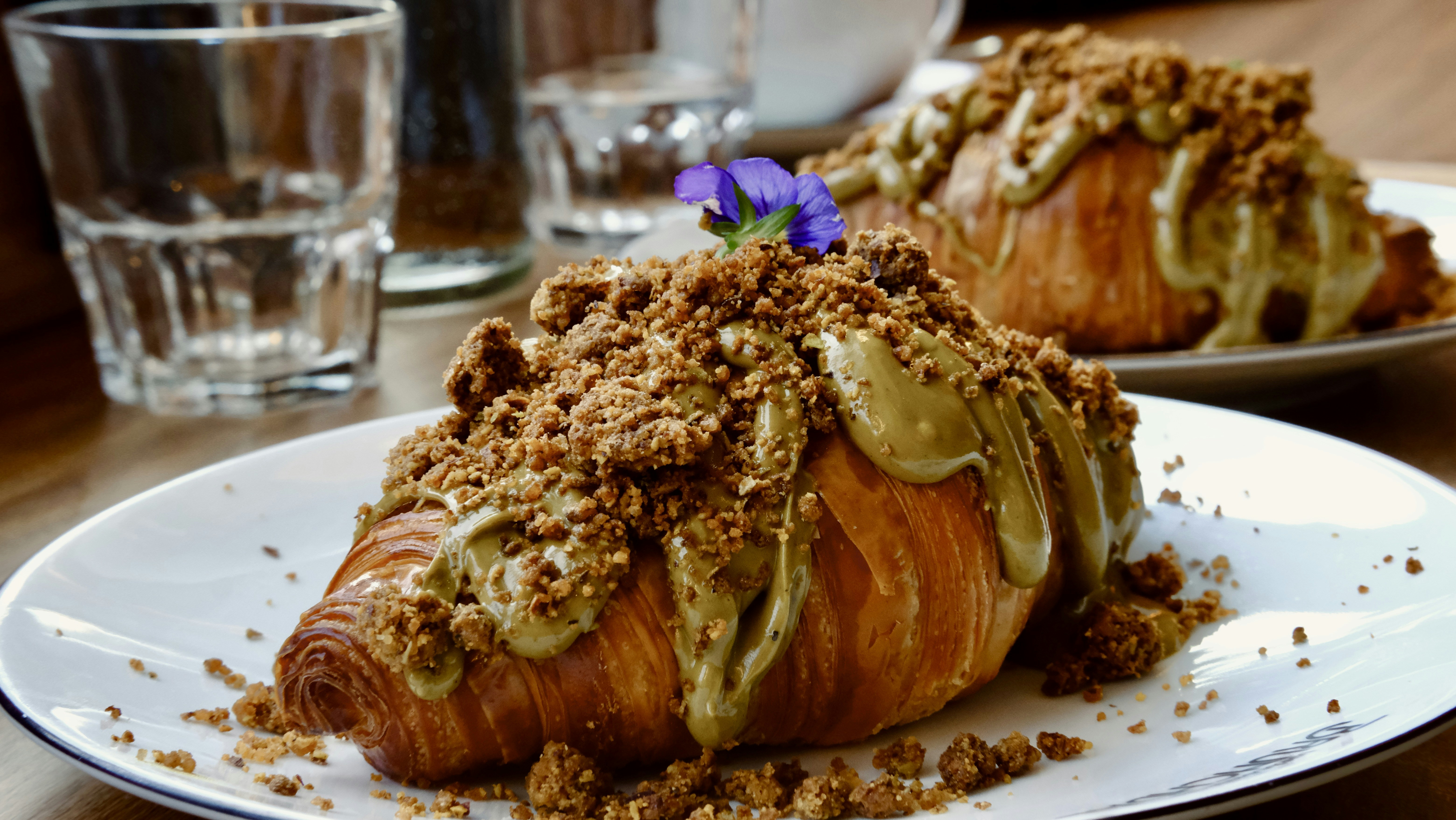 Croissants with pistachio cream and crumble are on display.