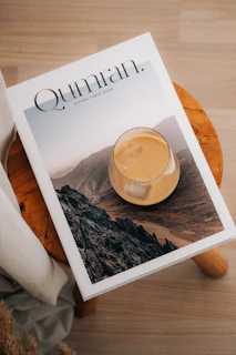 A drink and book on a wooden stool