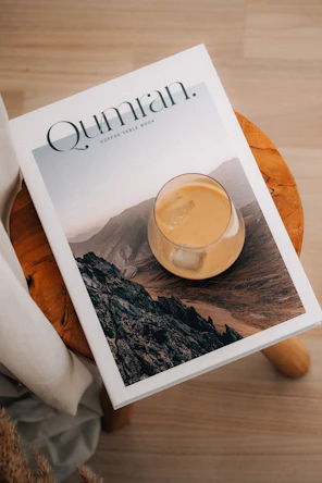 A drink and book on a wooden stool