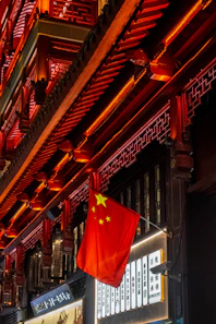 Chinese flag hangs outside a traditional building.