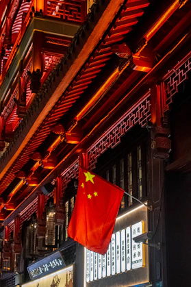 Chinese flag hangs outside a traditional building.
