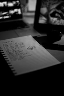A to-do list sits on a dimly lit desk.