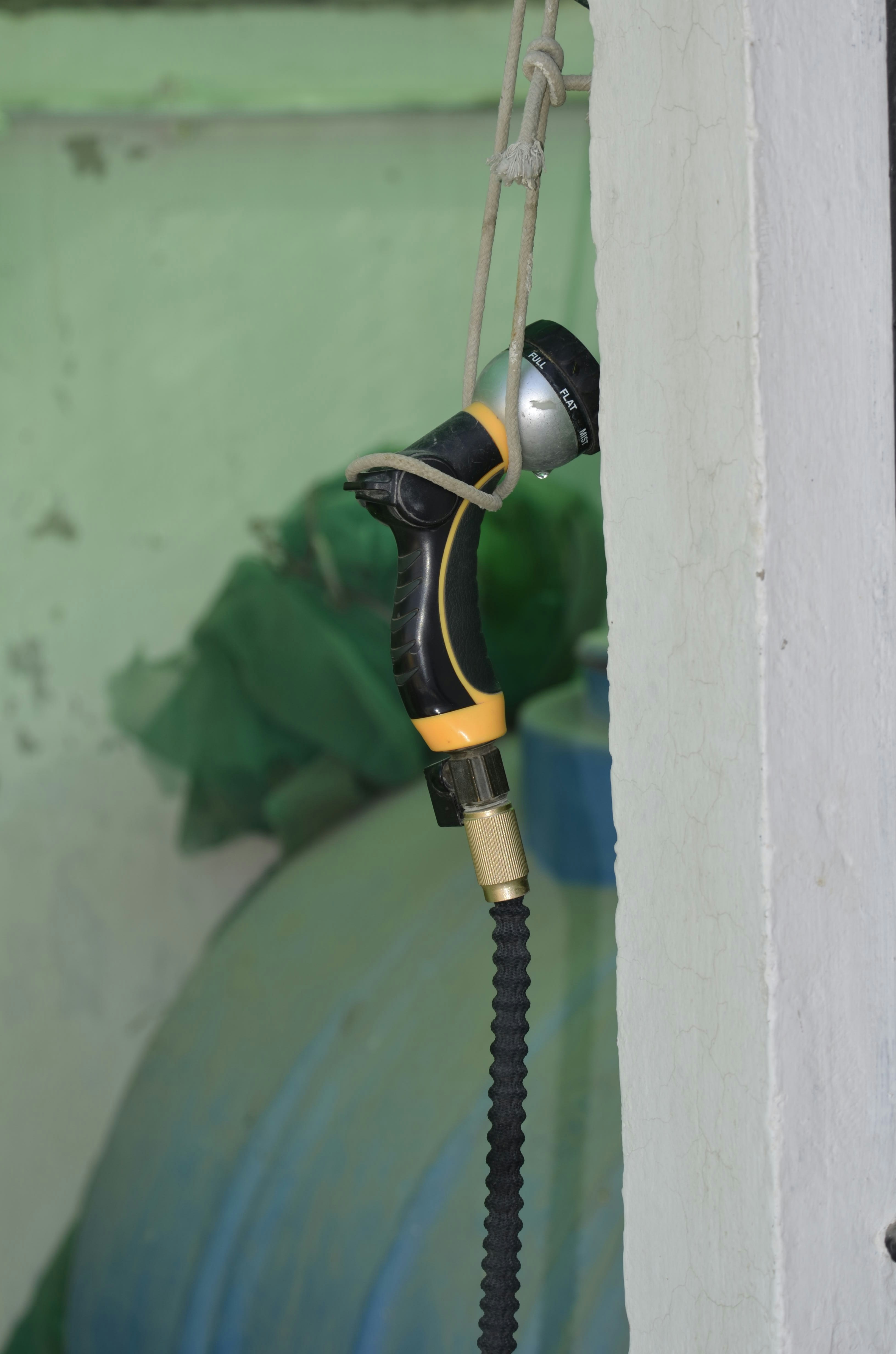A water sprayer hanging on a rope.