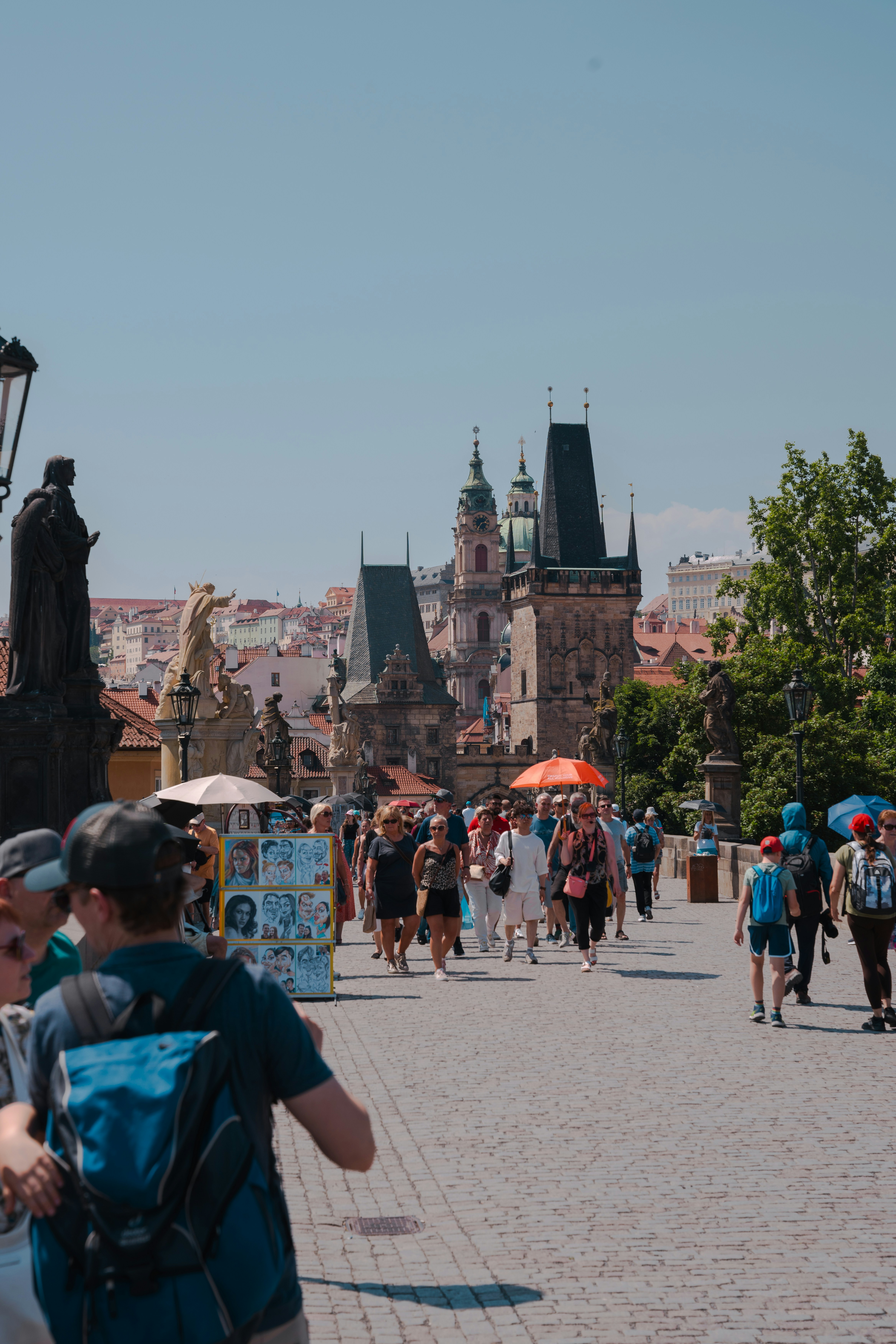 Tourists walk on a bridge with a beautiful skyline.