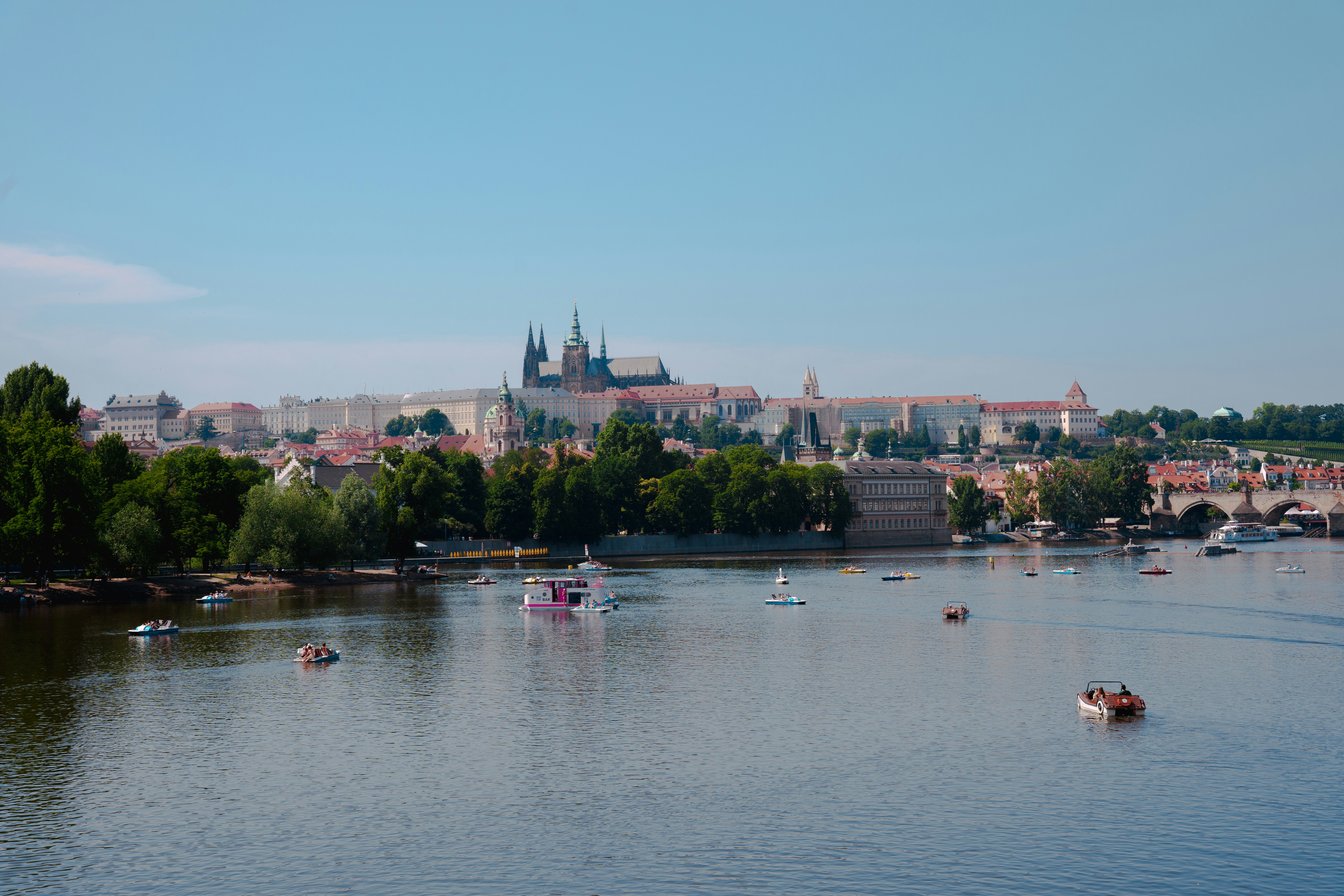 Prague castle overlooks the tranquil river below.