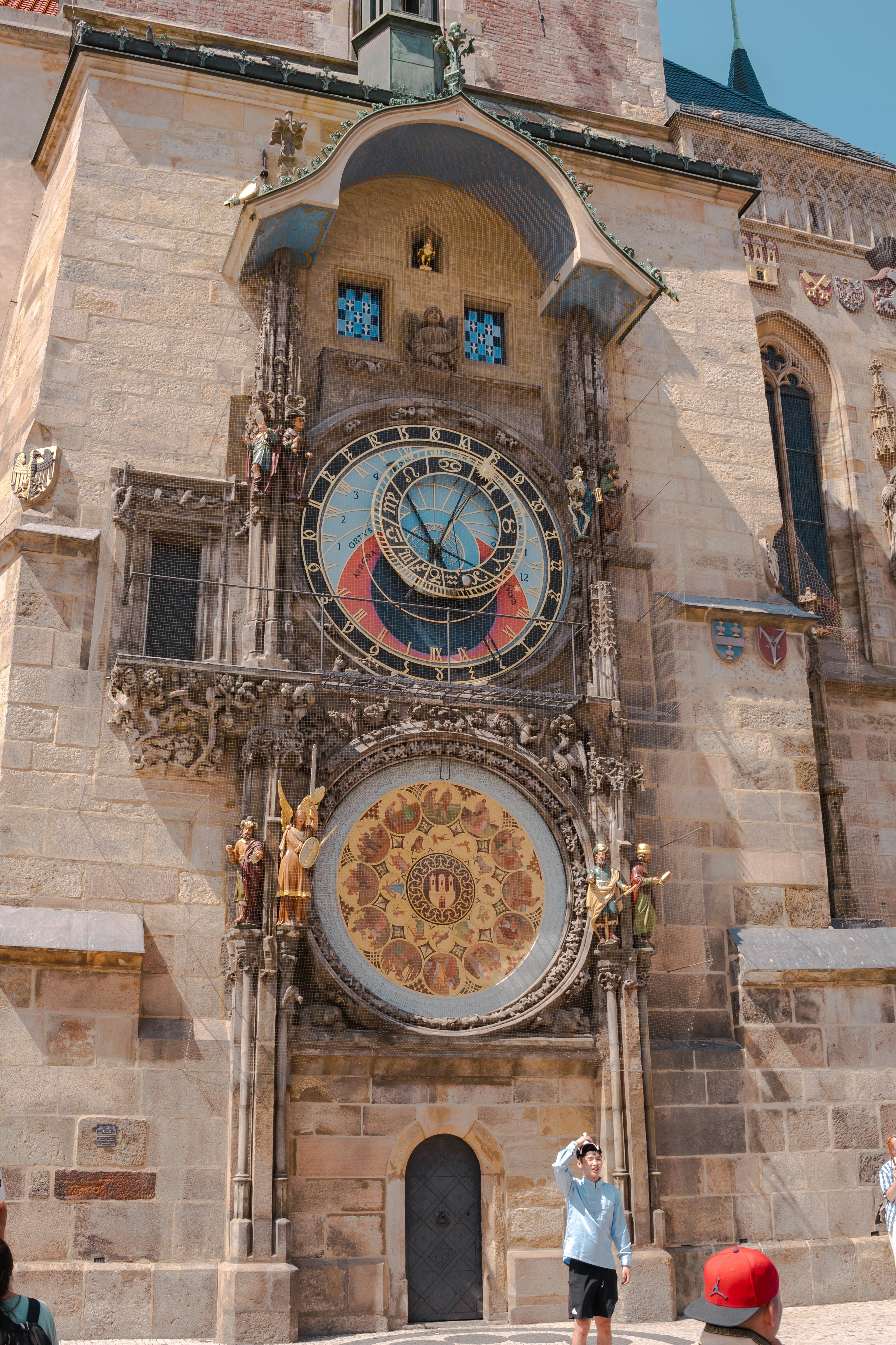 The prague astronomical clock stands on a building.