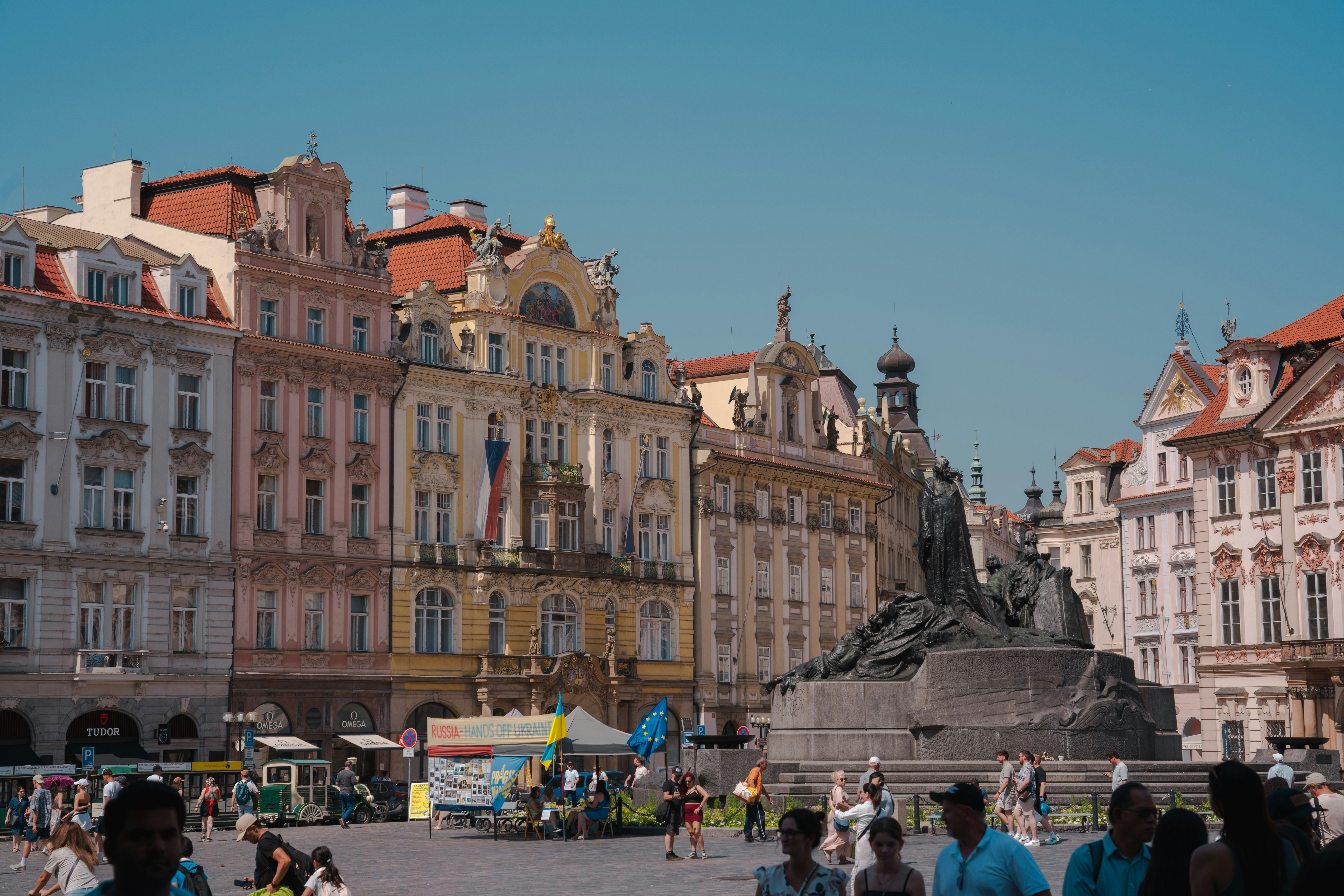 Buildings and a statue stand in a town square.