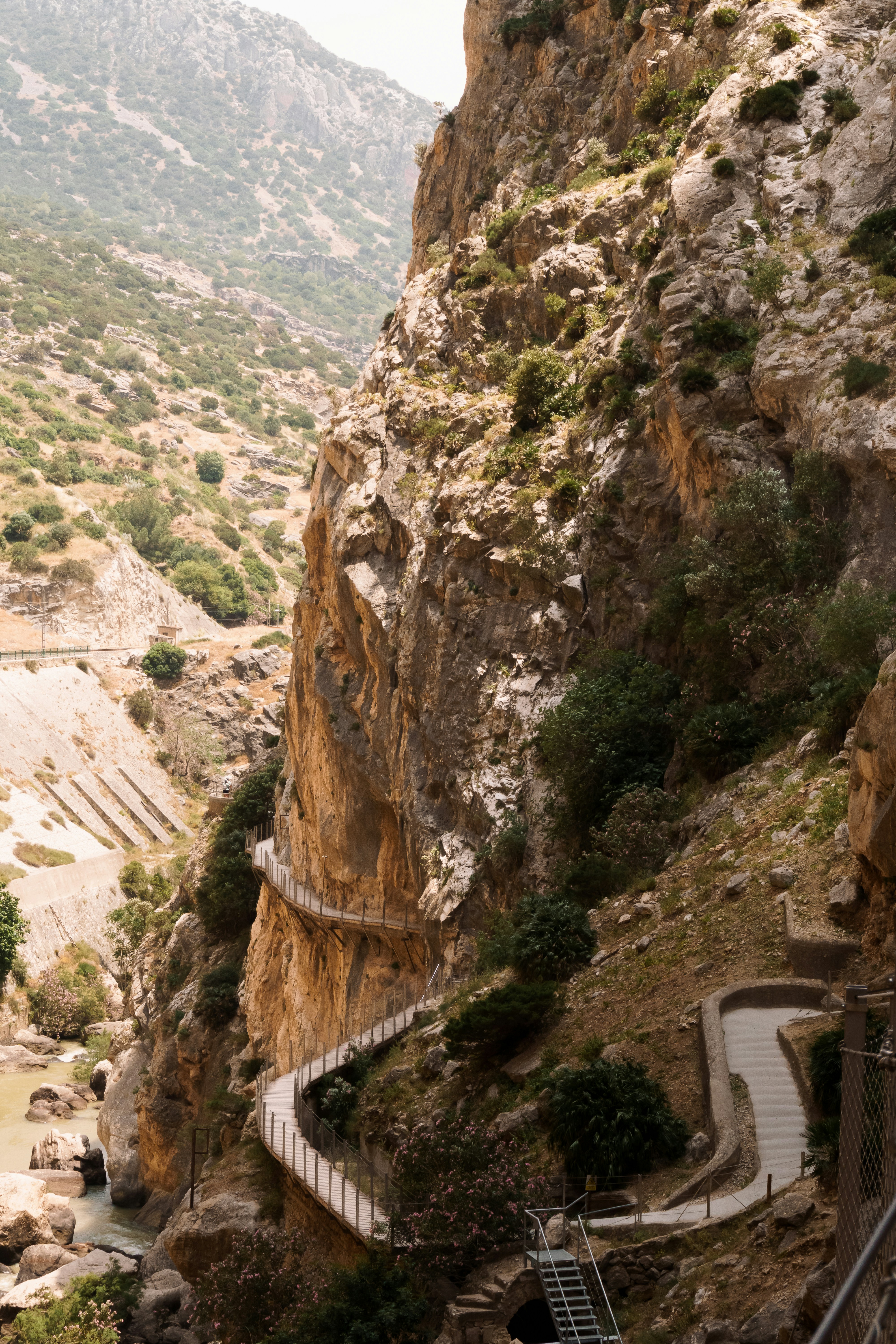 A pathway clings to a rocky cliffside.