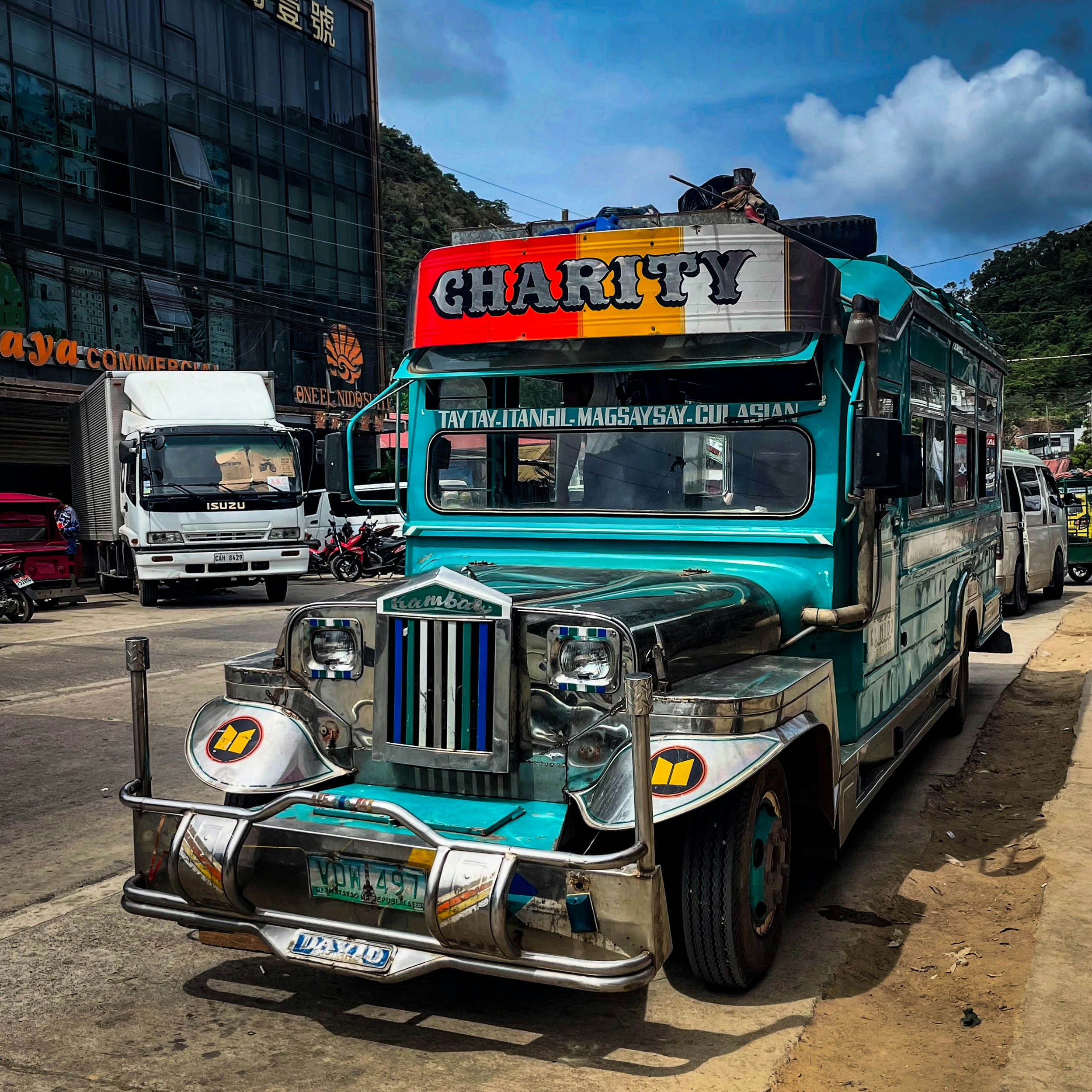 A colorful jeepney is parked on the street.