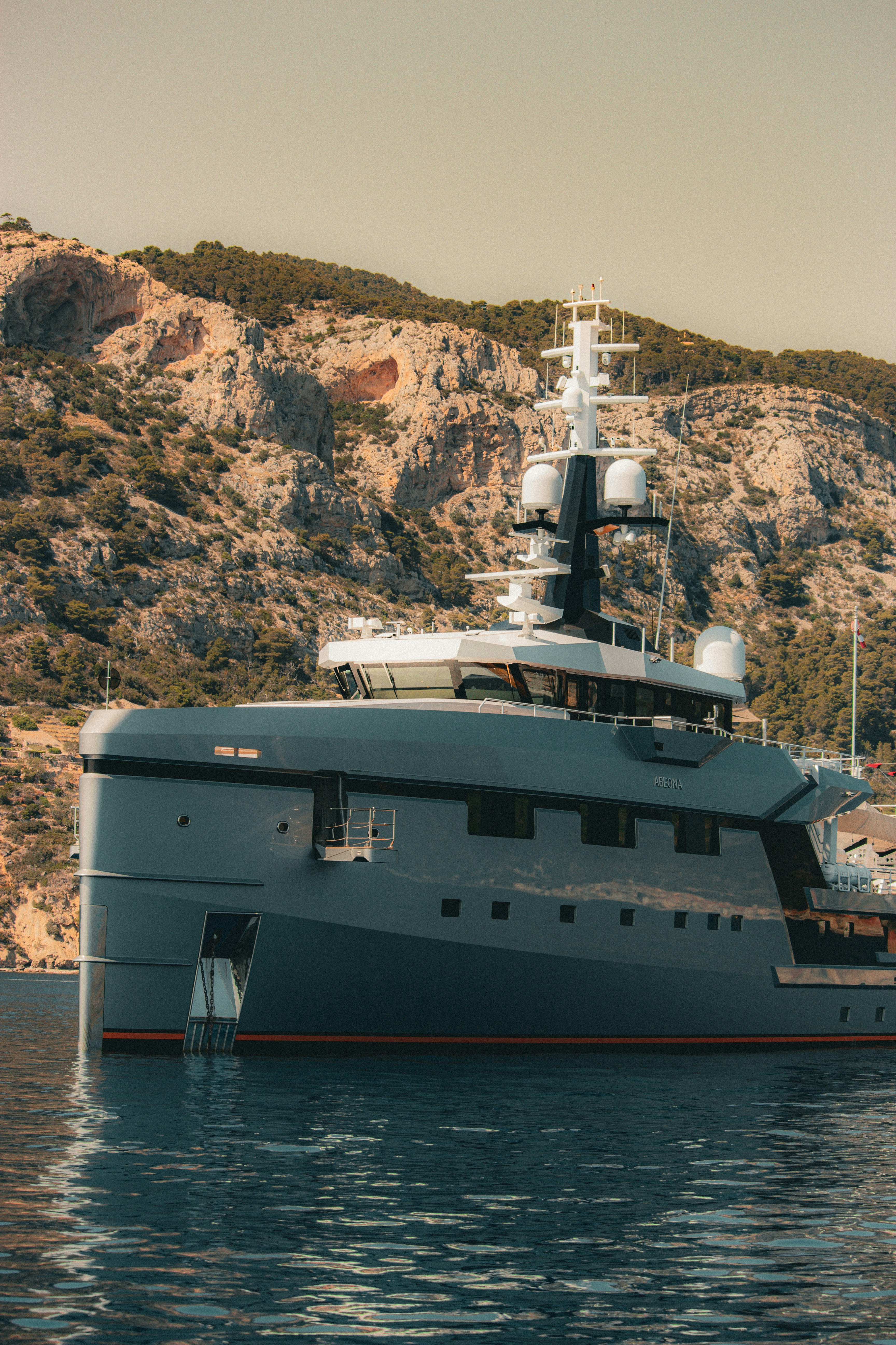 A luxury yacht sits in calm waters.
