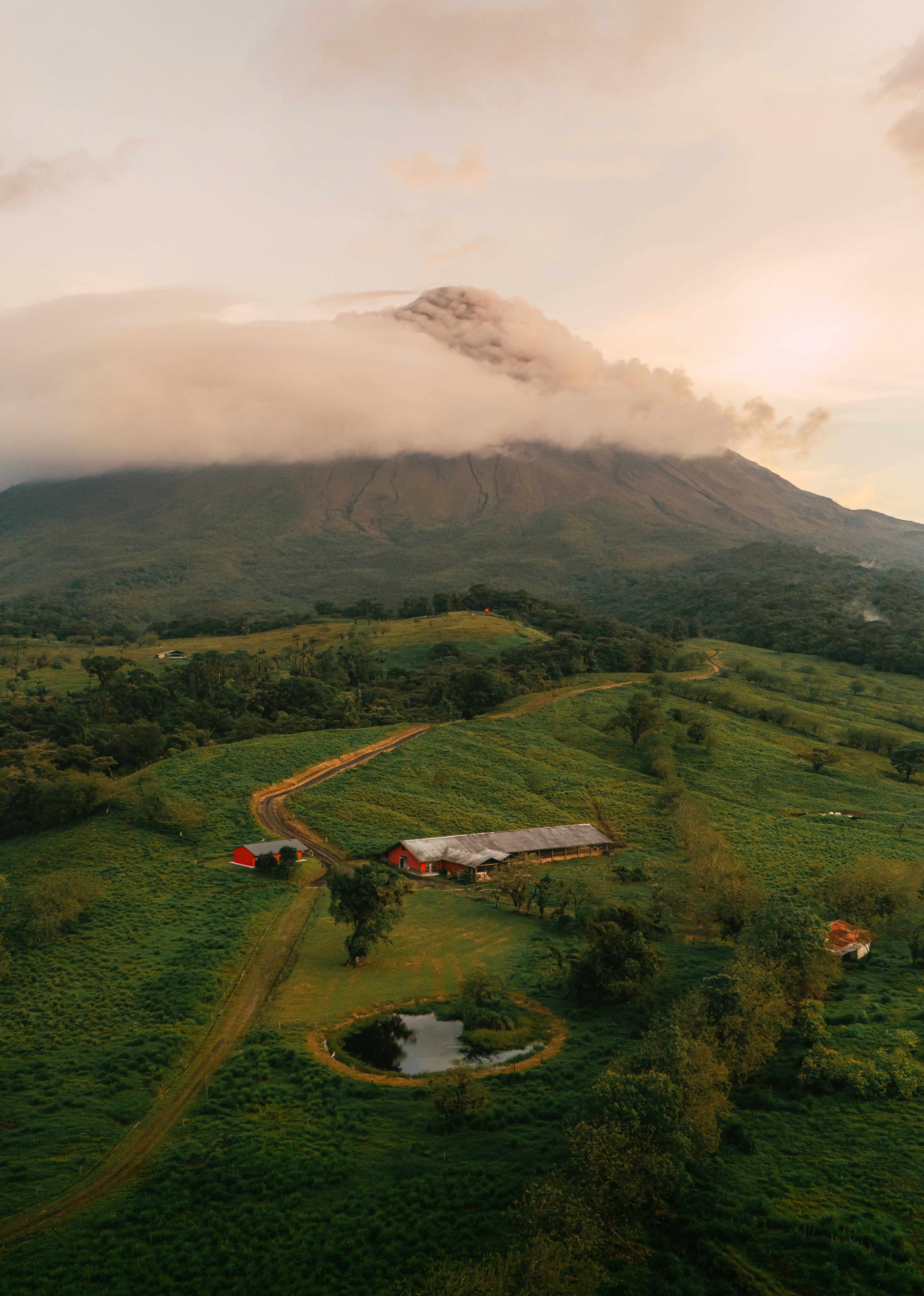 A volcano looms over a lush green landscape.