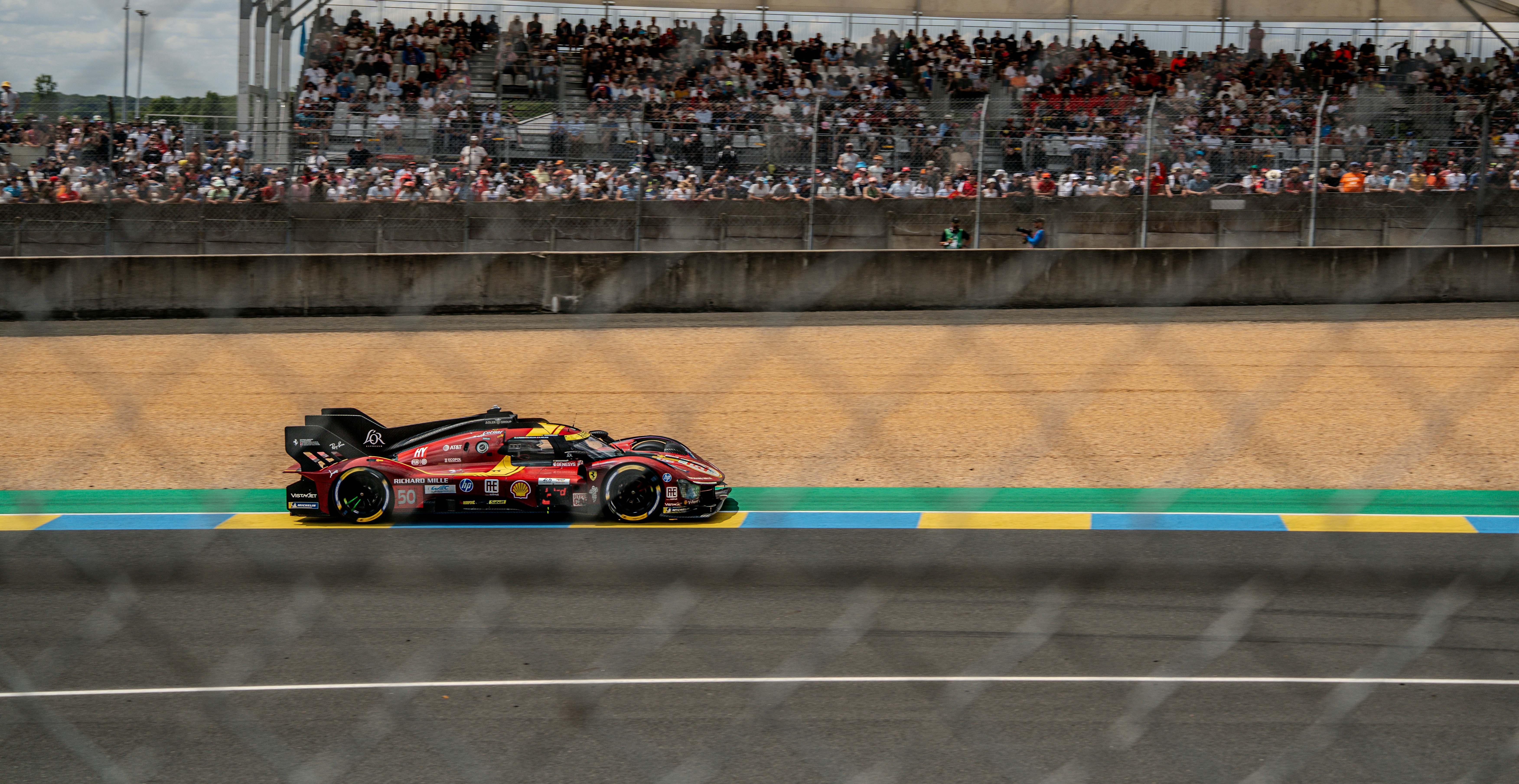 A race car speeds down the track.