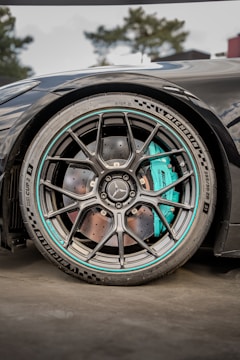 A black mercedes car wheel shows detail.