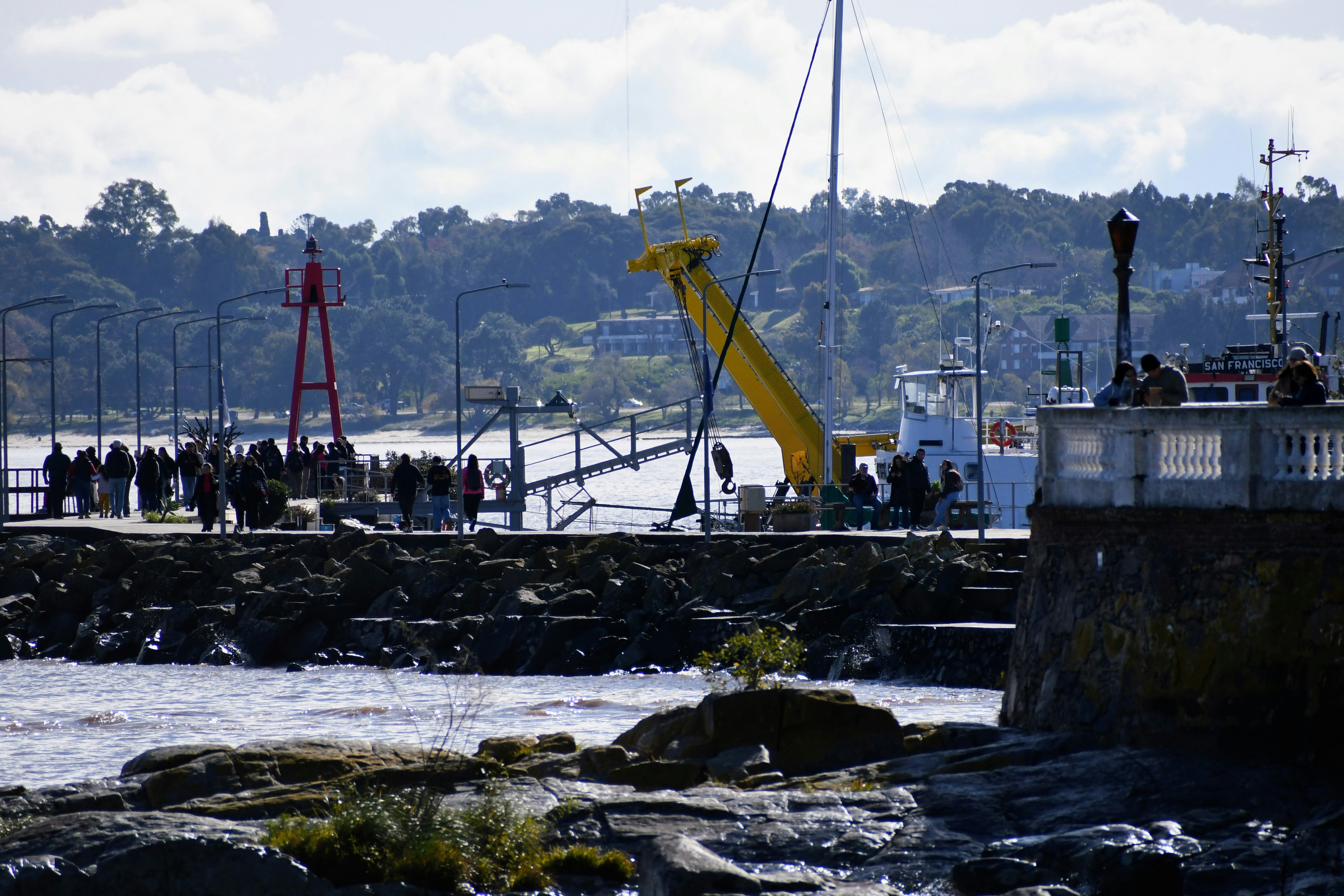 Animation portuaire avec des bateaux et des passants profitant de l ambiance maritime lors d une journée ensoleillée