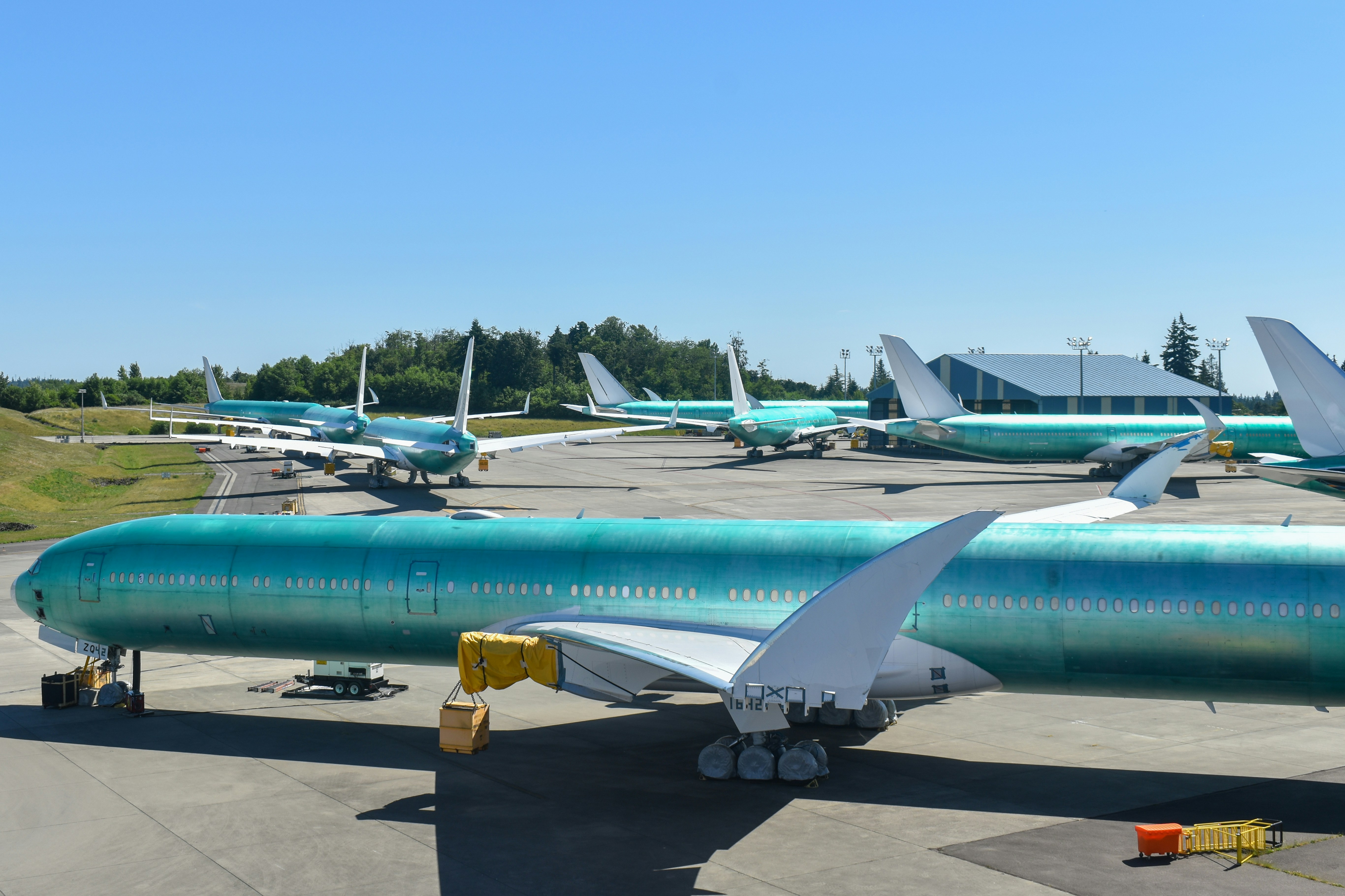 Airplanes sit in a hangar.