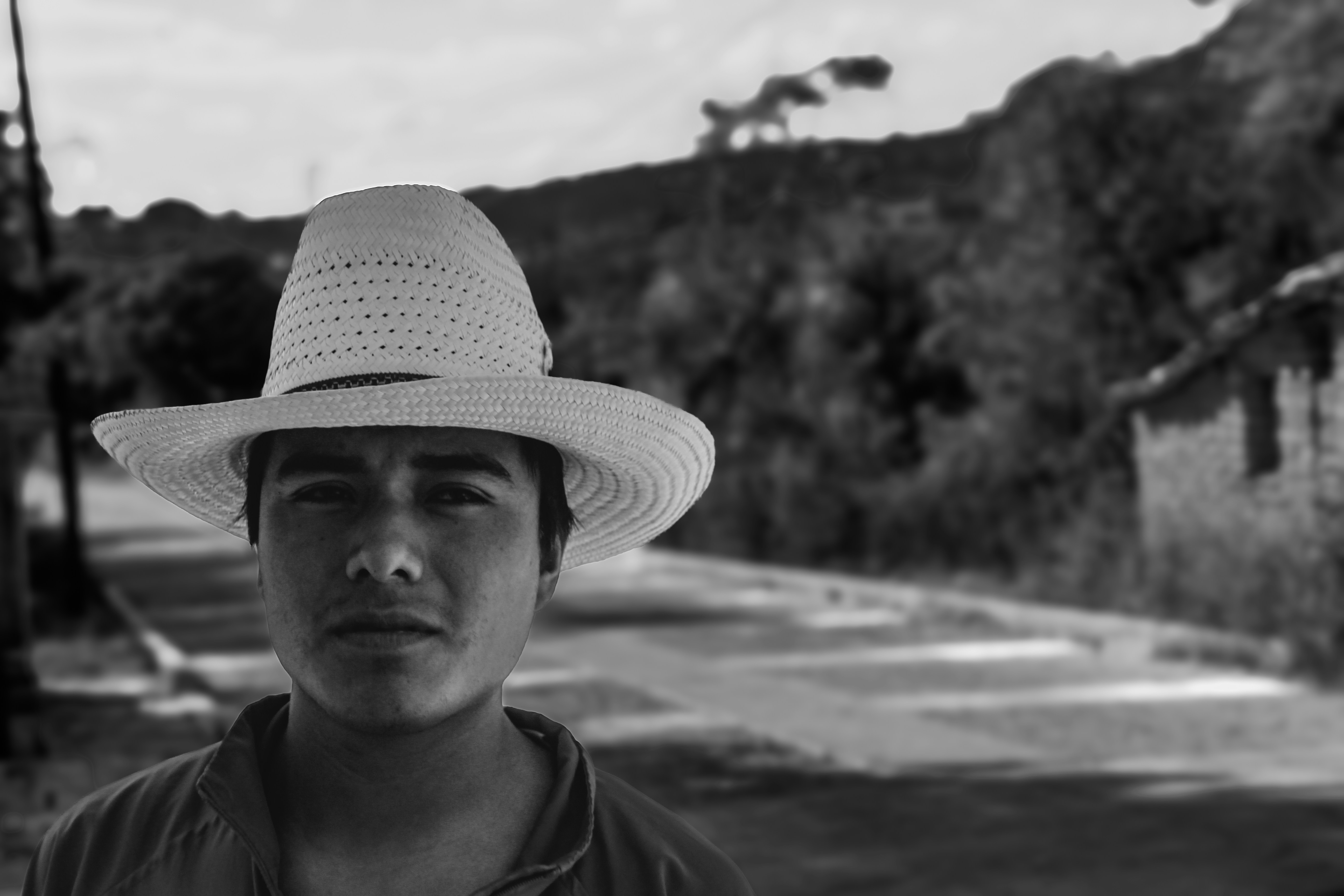 A man in a hat poses for a portrait.