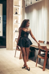 Woman poses in fashionable outfit.