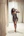 Woman poses elegantly in a fancy, modern hallway.