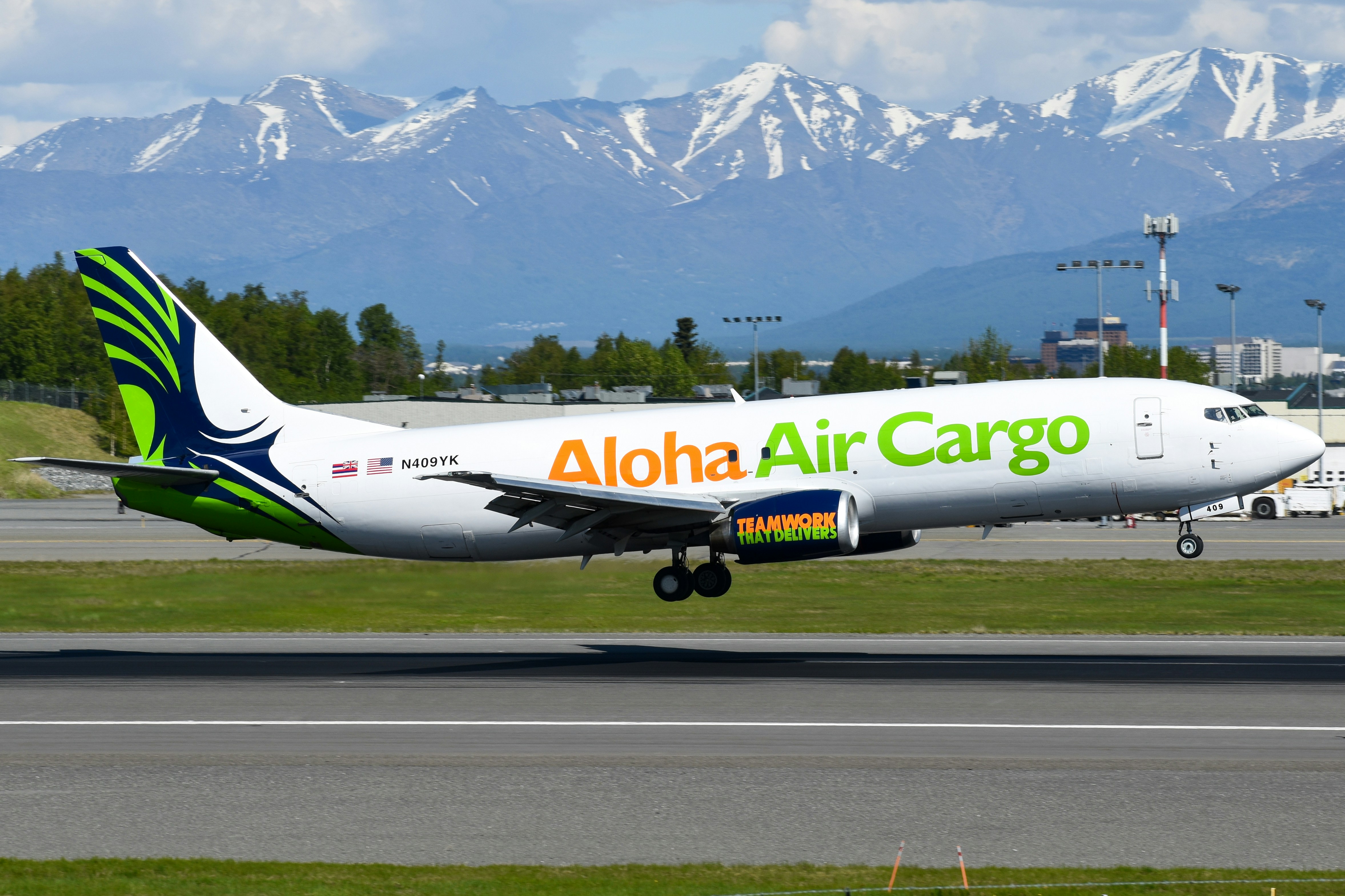 An aloha air cargo airplane is landing.