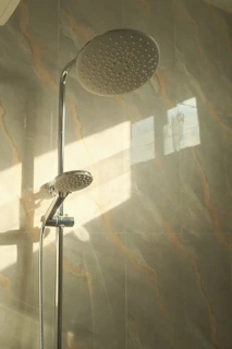 A shower head is illuminated by sunlight