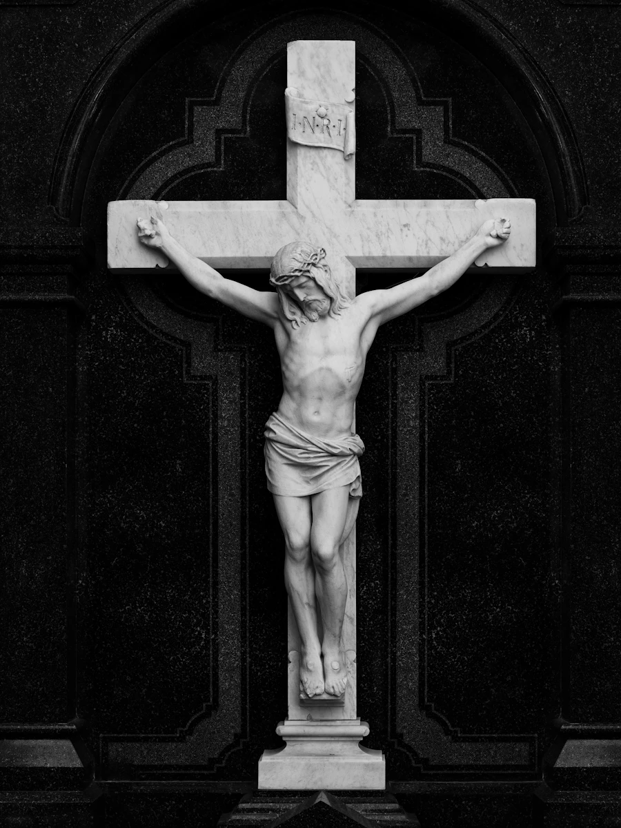 Jesus Christ crucified on a cross, depicted in marble sculpture