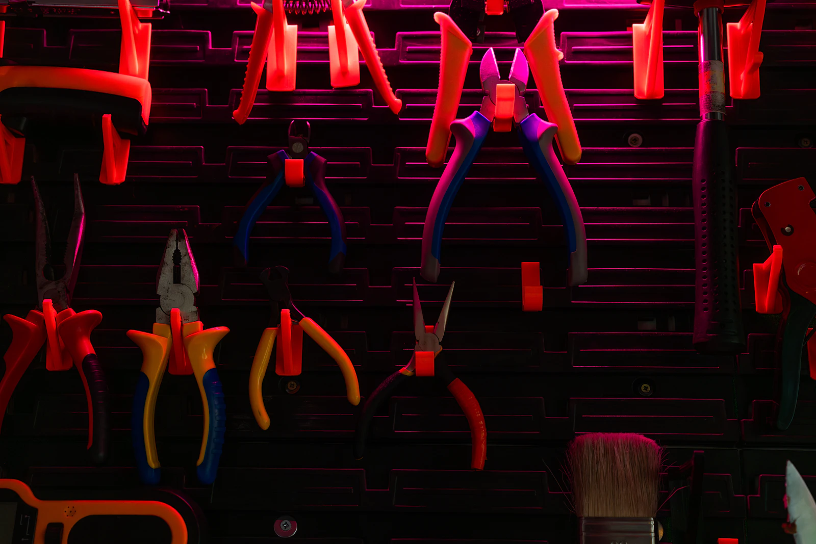 A workshop wall hung with hand tools of every kind, arranged for training