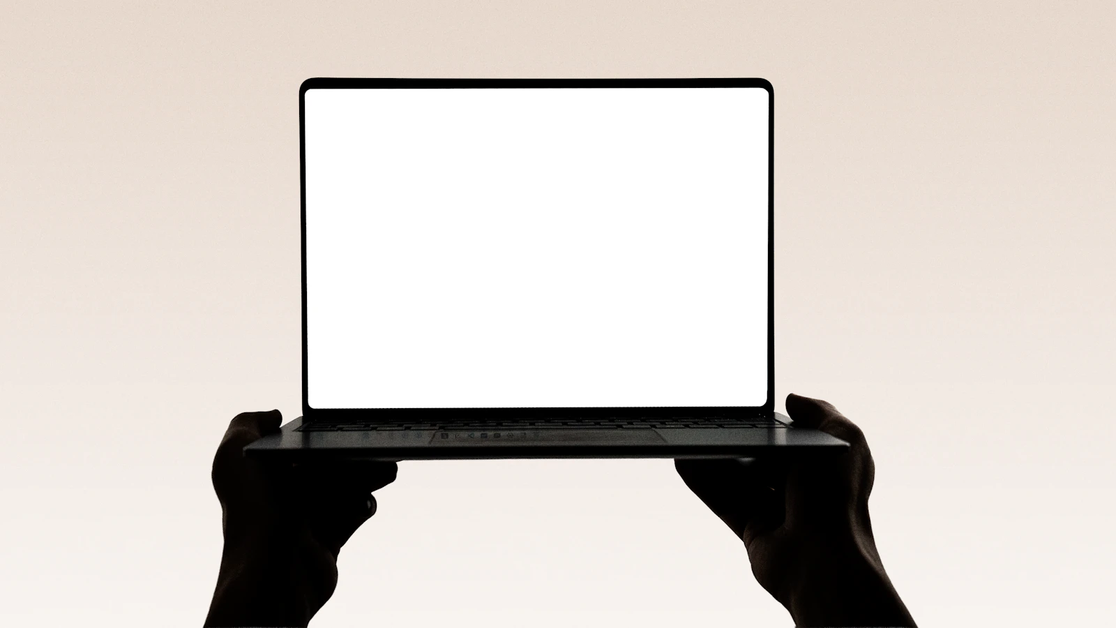 Hands holding an open laptop, suggesting wrapping up the workday and shipping