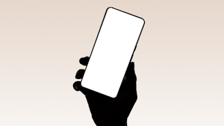 A hand holds up a smartphone.