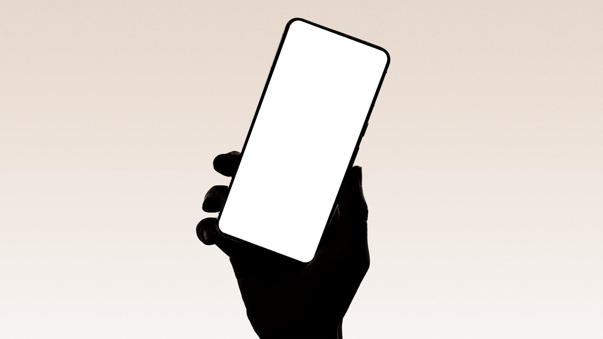A hand holds up a smartphone.