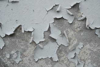 Flaking paint shows its age on a weathered surface.
