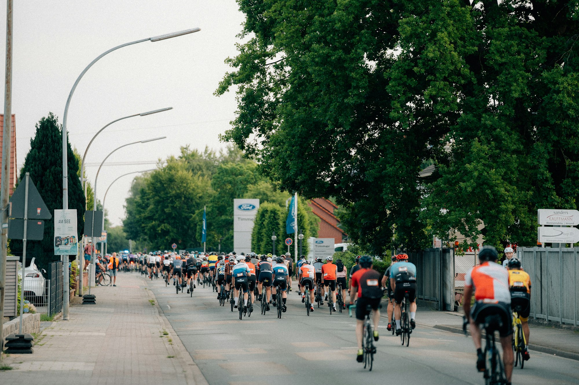 A group of cyclists racing down a road.