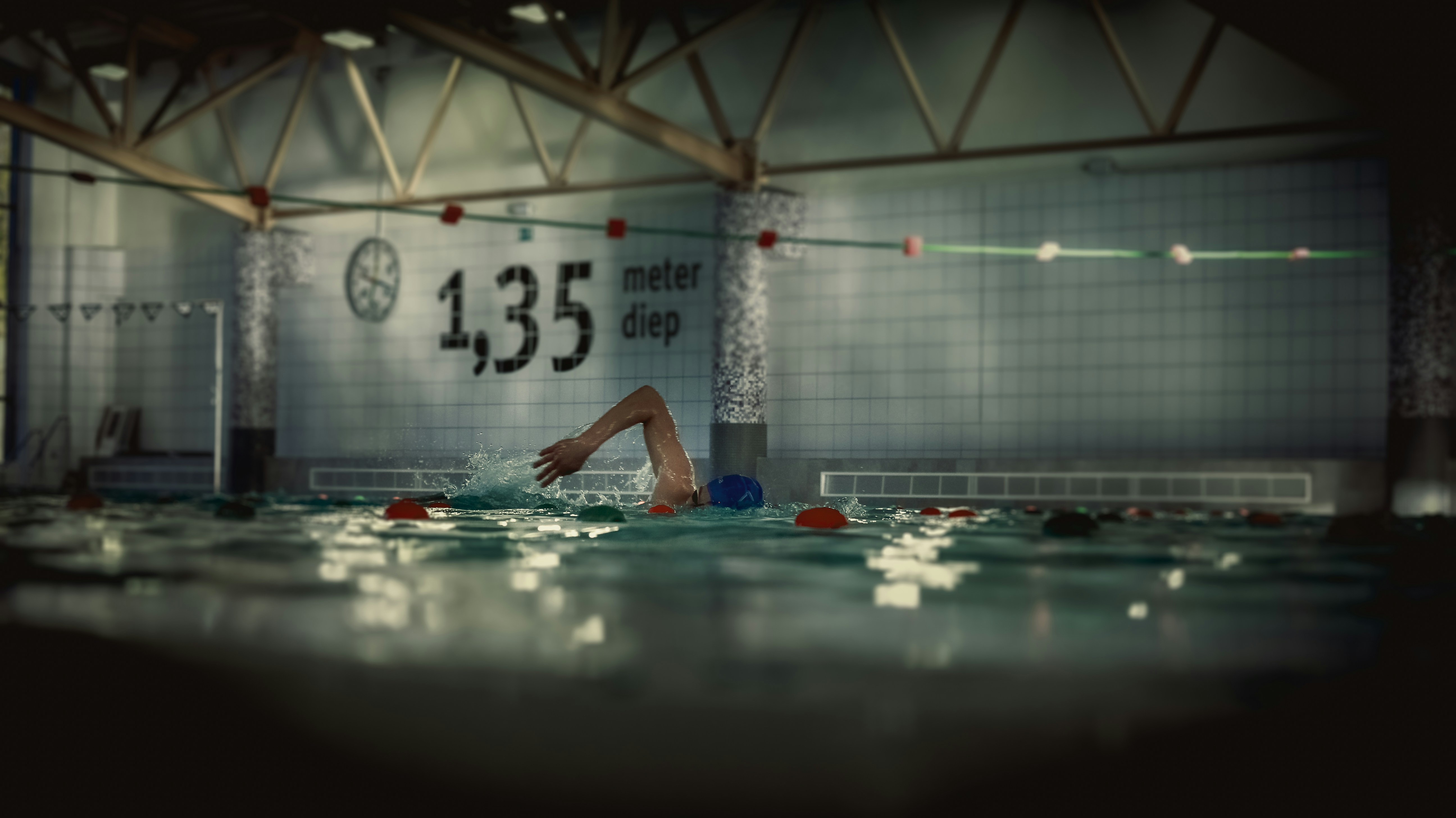A swimmer is doing backstroke in a pool.